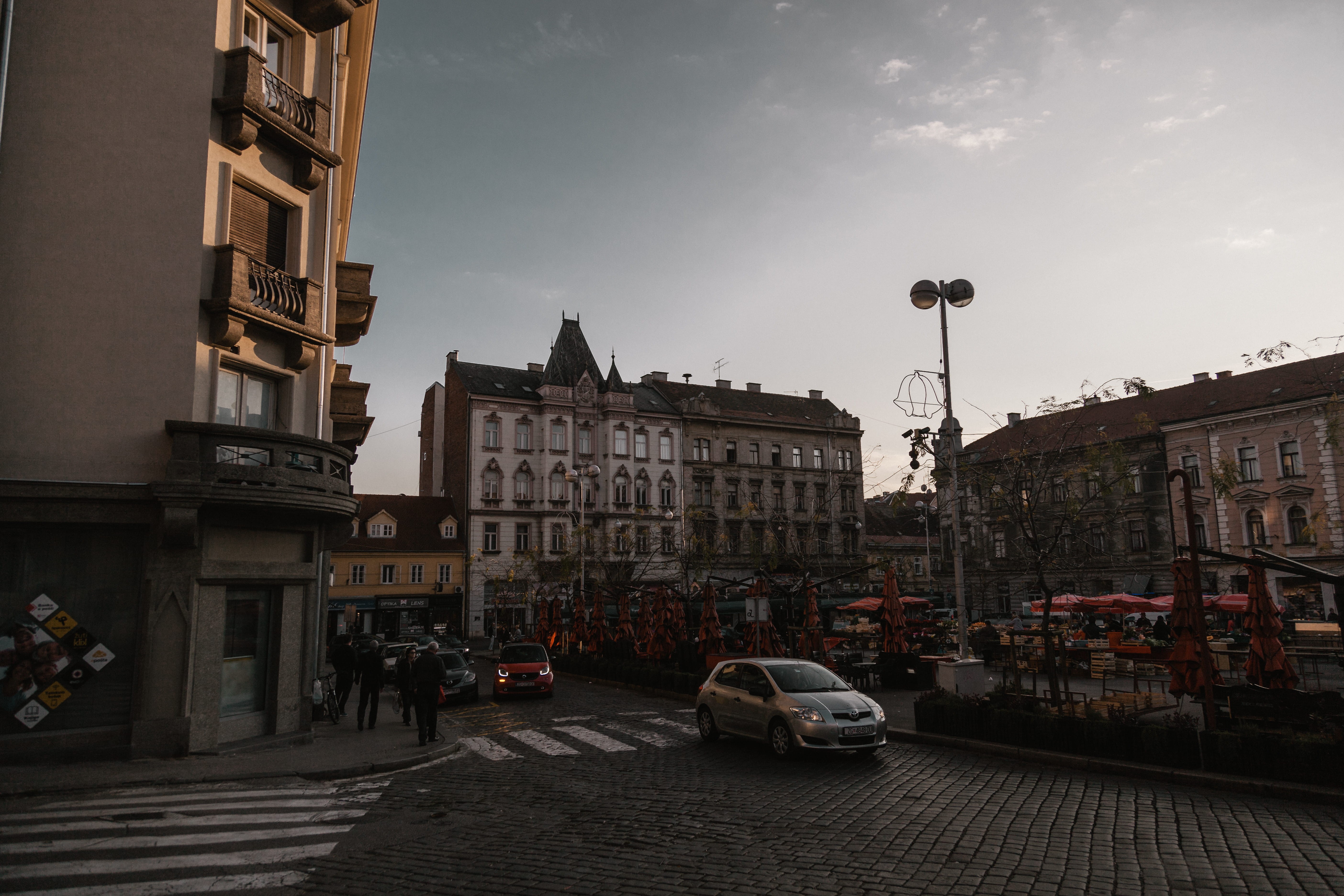 urban photography, cloud - sky, building, car, city street, moody, transportation, sky, street light, urban, wide, architecture, road, outdoors, mode of transportation, HD Wallpaper