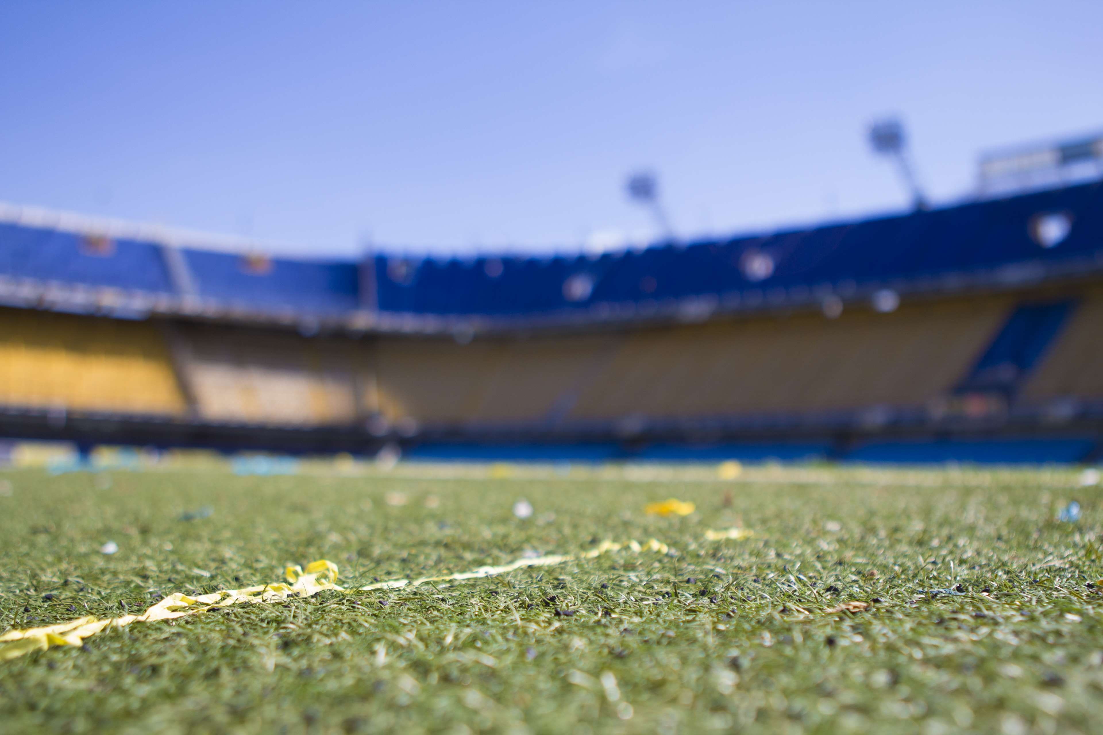 selective focus, football, day, surface level, 4K, lawn, afternoon, clear sky, barcelona, no people, american football - sport, outdoors, sky, grass, stadium, HD Wallpaper