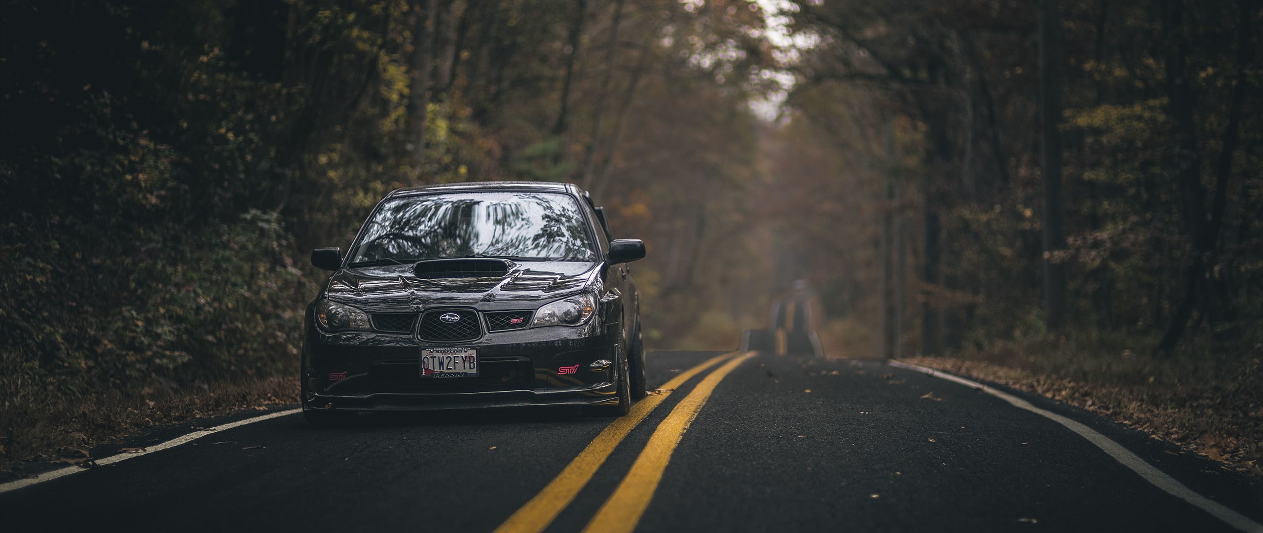 outdoors, tree, forest, sign, day, ultra wide car subaru impreza rally, car, road marking, 2K, land vehicle, mode of transportation, land, symbol, no people, HD Wallpaper