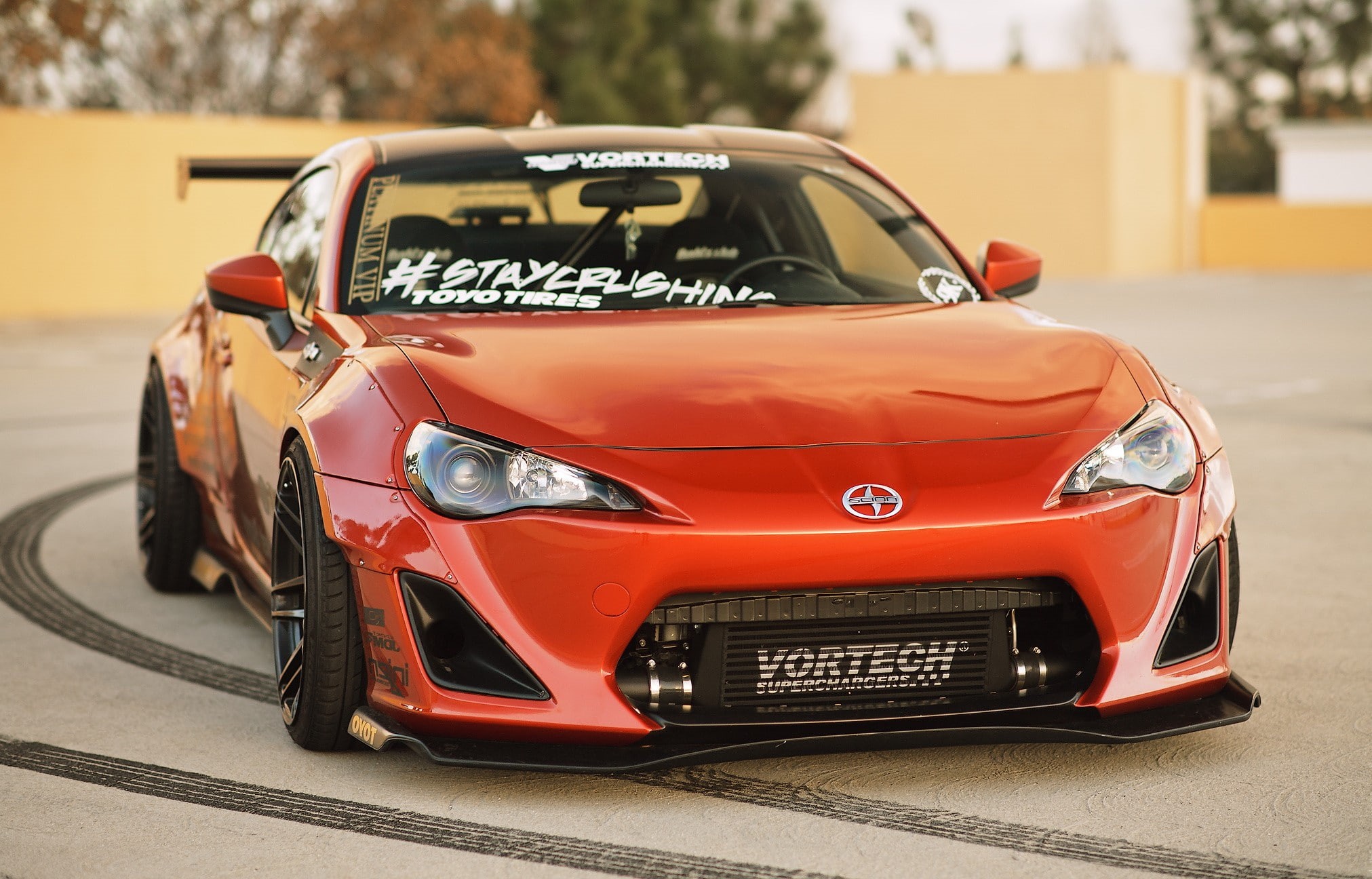 sports car, day, street, text, land vehicle, outdoors, western script, red, vintage car, city, focus on foreground, Scion, sunlight, number, Toyota, mode of transportation, HD Wallpaper