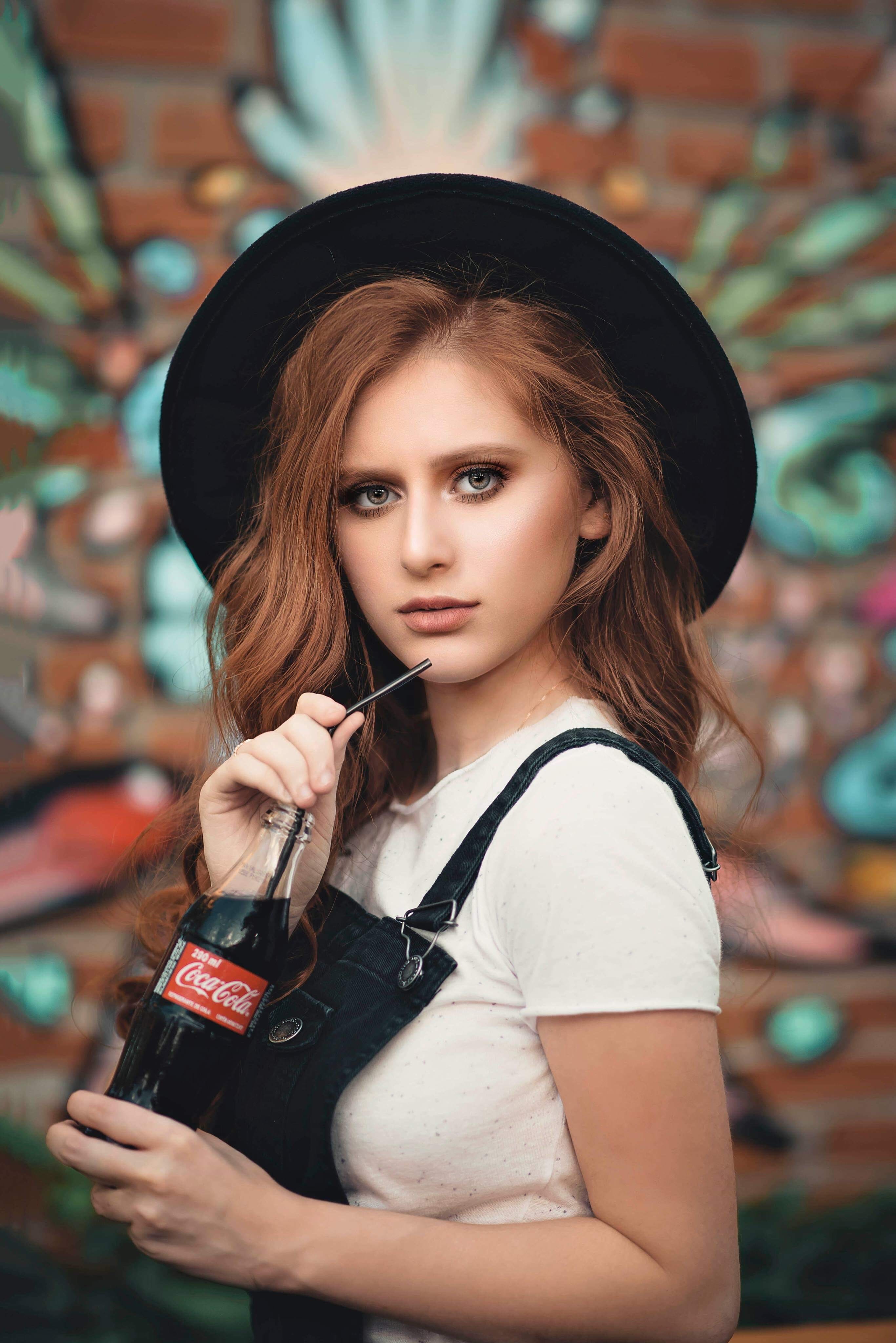 focus on foreground, indoors, beautiful, fashion, adolescent, pretty, cola, real people, drink, standing, pose, outdoors, shirt, holding, one person, glamour, Phone HD Wallpaper