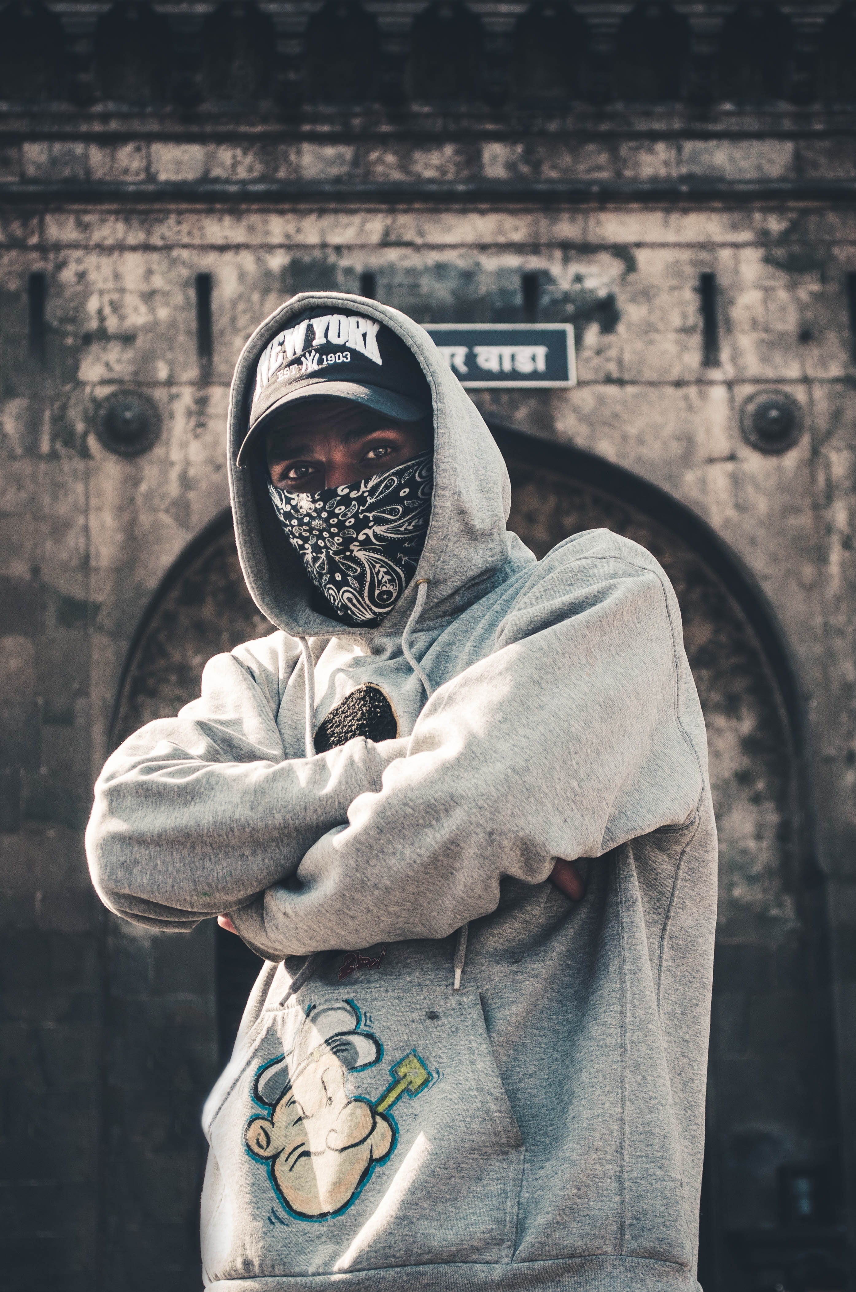 pullover, focus on foreground, brown, male, near, mask, printed, city, real people, architecture, waist up, portrait, day, building exterior, adult, three quarter length, Phone HD Wallpaper