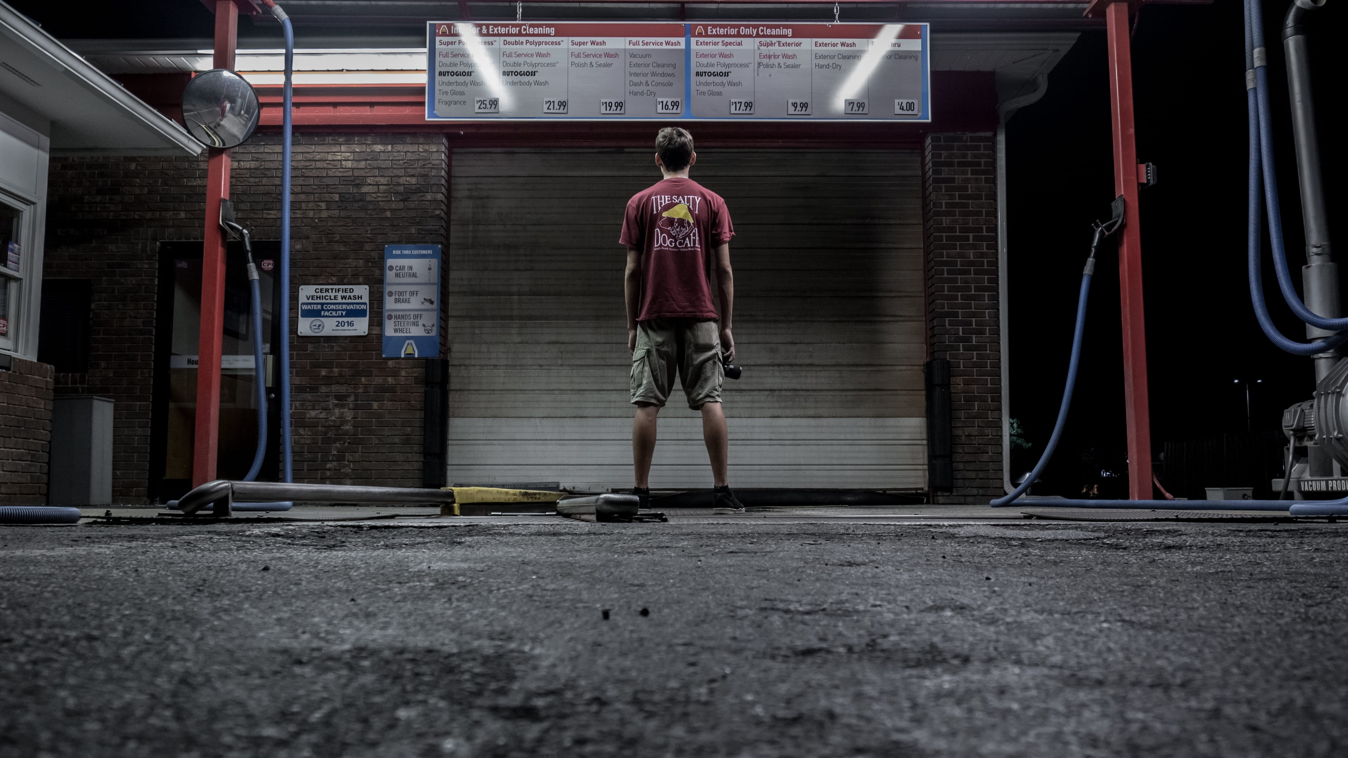 person, pavement, building, uniform, men, gray, standing, warehouse, architecture, rear view, dark, working, garage, man, holding, young adult, front, brown, HD Wallpaper