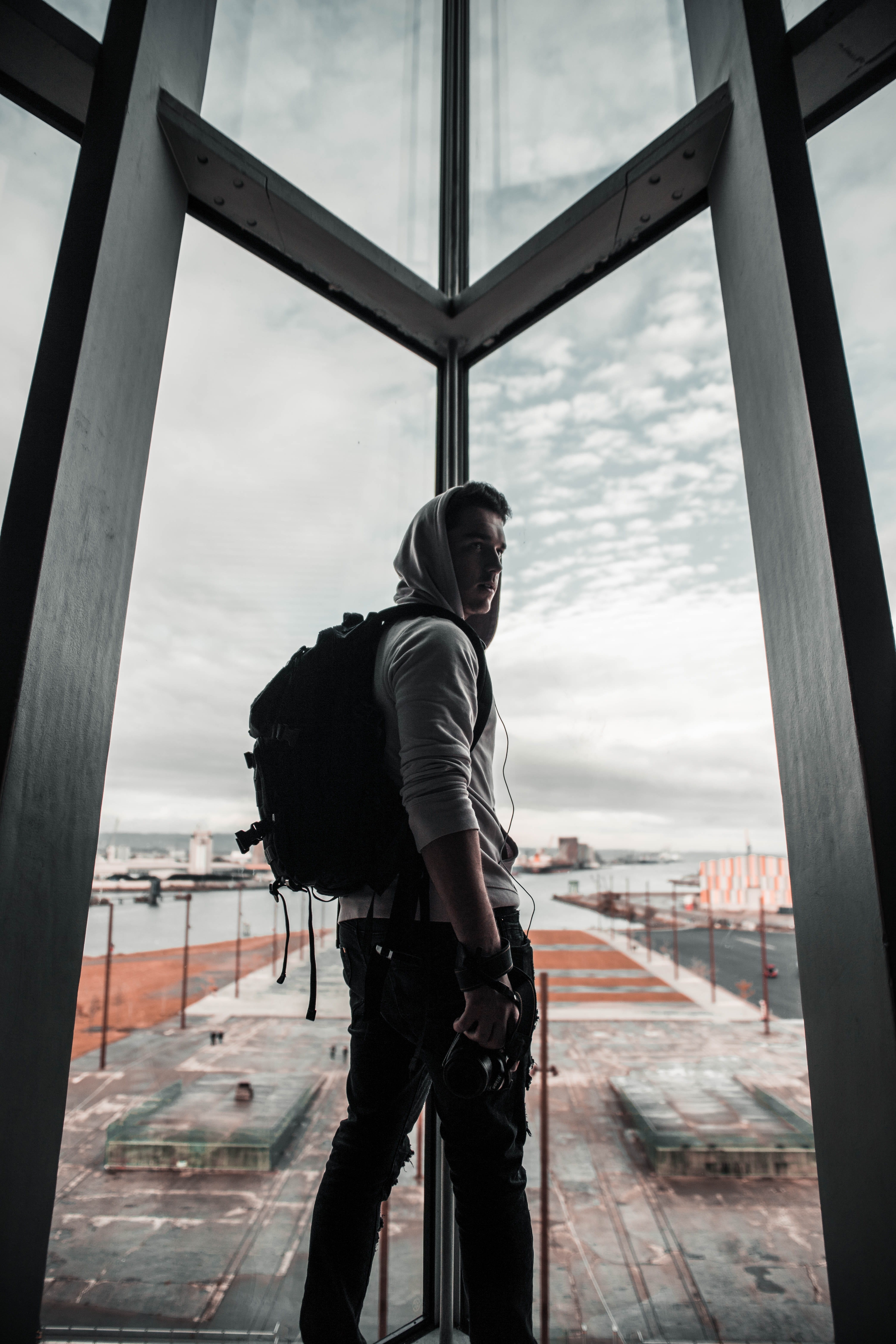 contemplation, apparel, nature, bag, gown, 5K, sliding door, cameraman, windows, glass, outdoors, men, lifestyles, fashion, backpack, sky, pants, day, Phone HD Wallpaper