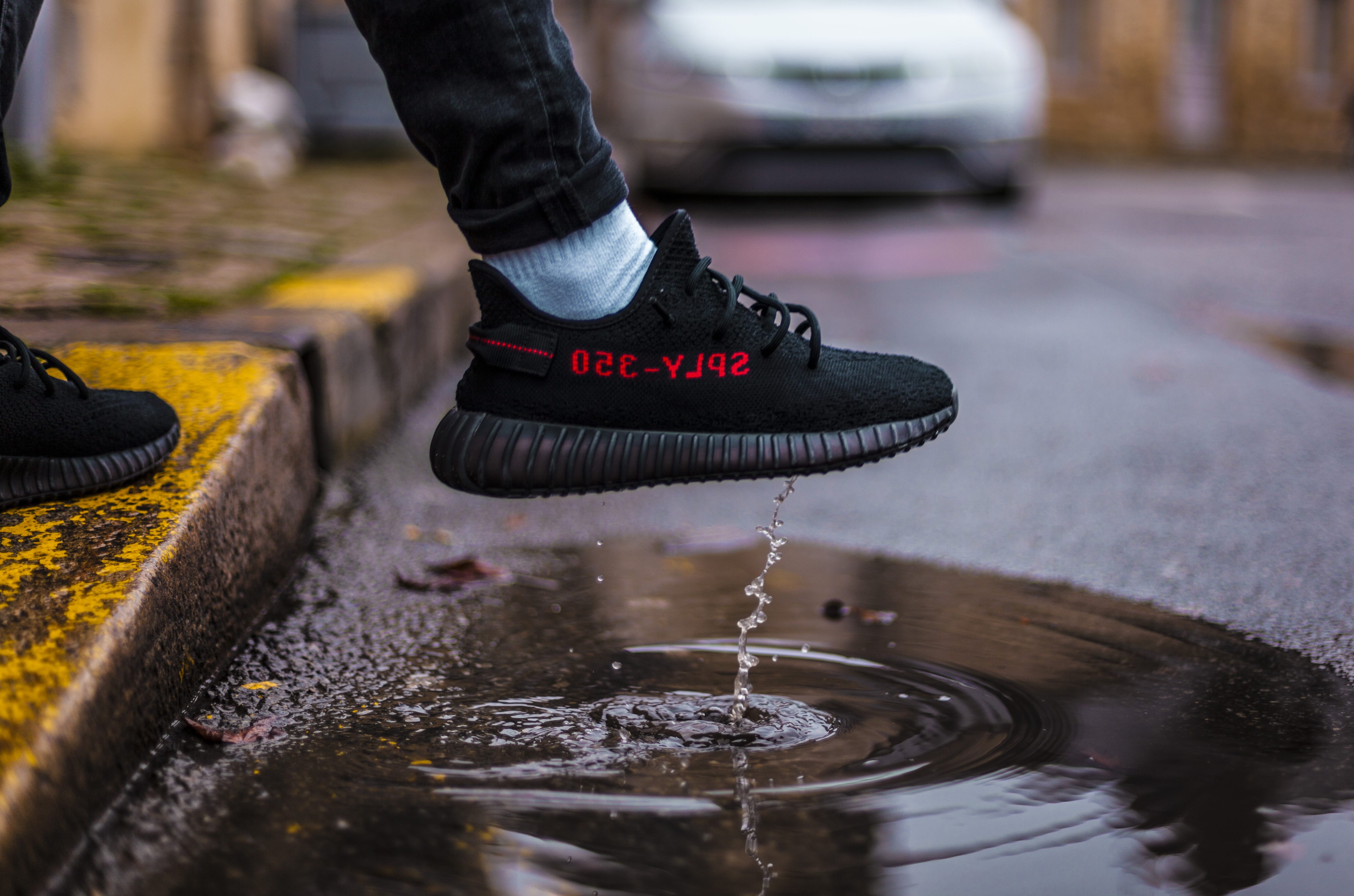 wearing, human leg, one person, puddle, outdoors, wheel, yeezy, nature, droplet, adidas, human limb, road, body part, 4K, bred, street, shoes, stepping, HD Wallpaper
