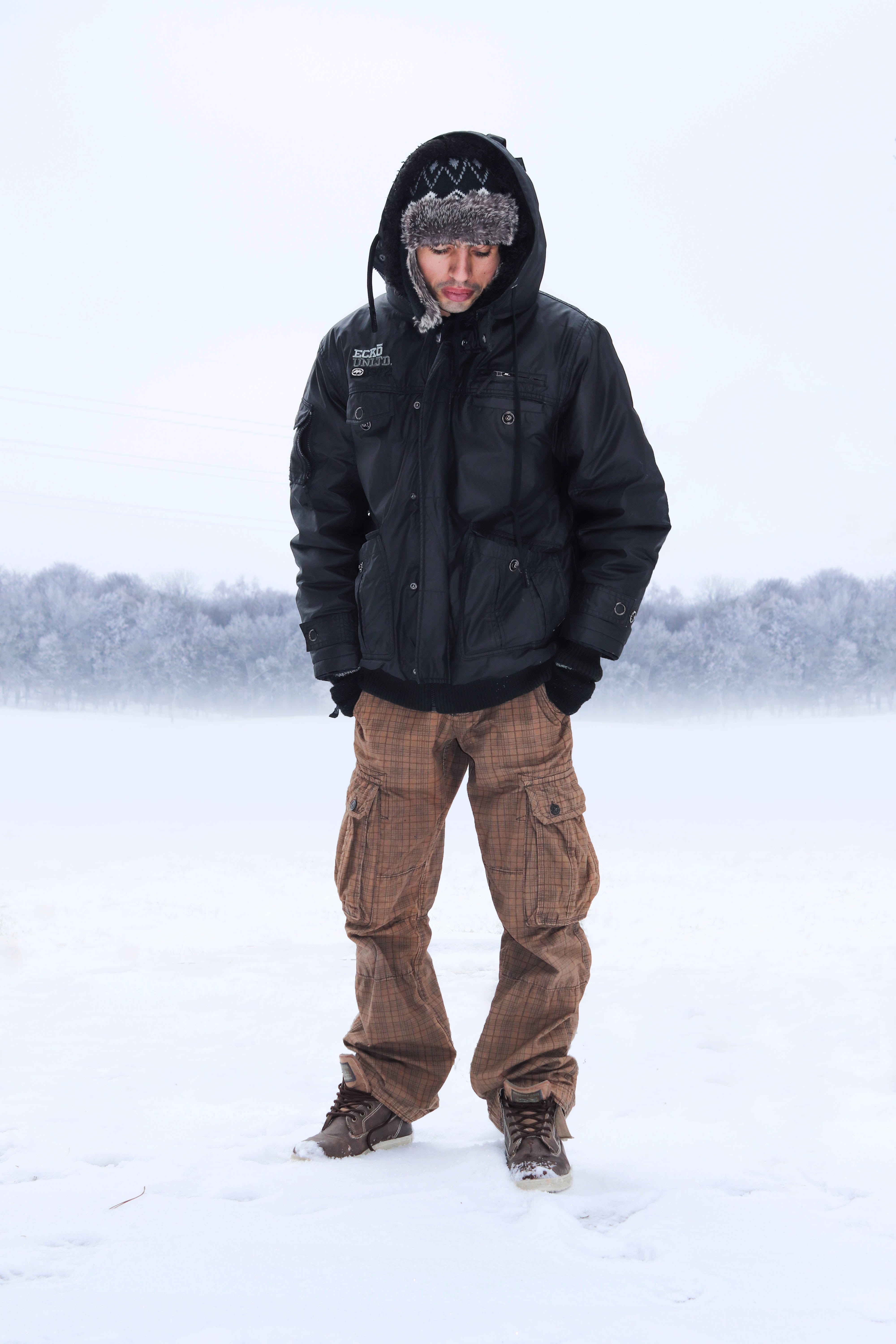 black, black color, coat, sport, skating, looking at camera, trees, person, fashion, land, extreme weather, outdoors, looking, apparel, real people, leisure activity, Phone HD Wallpaper