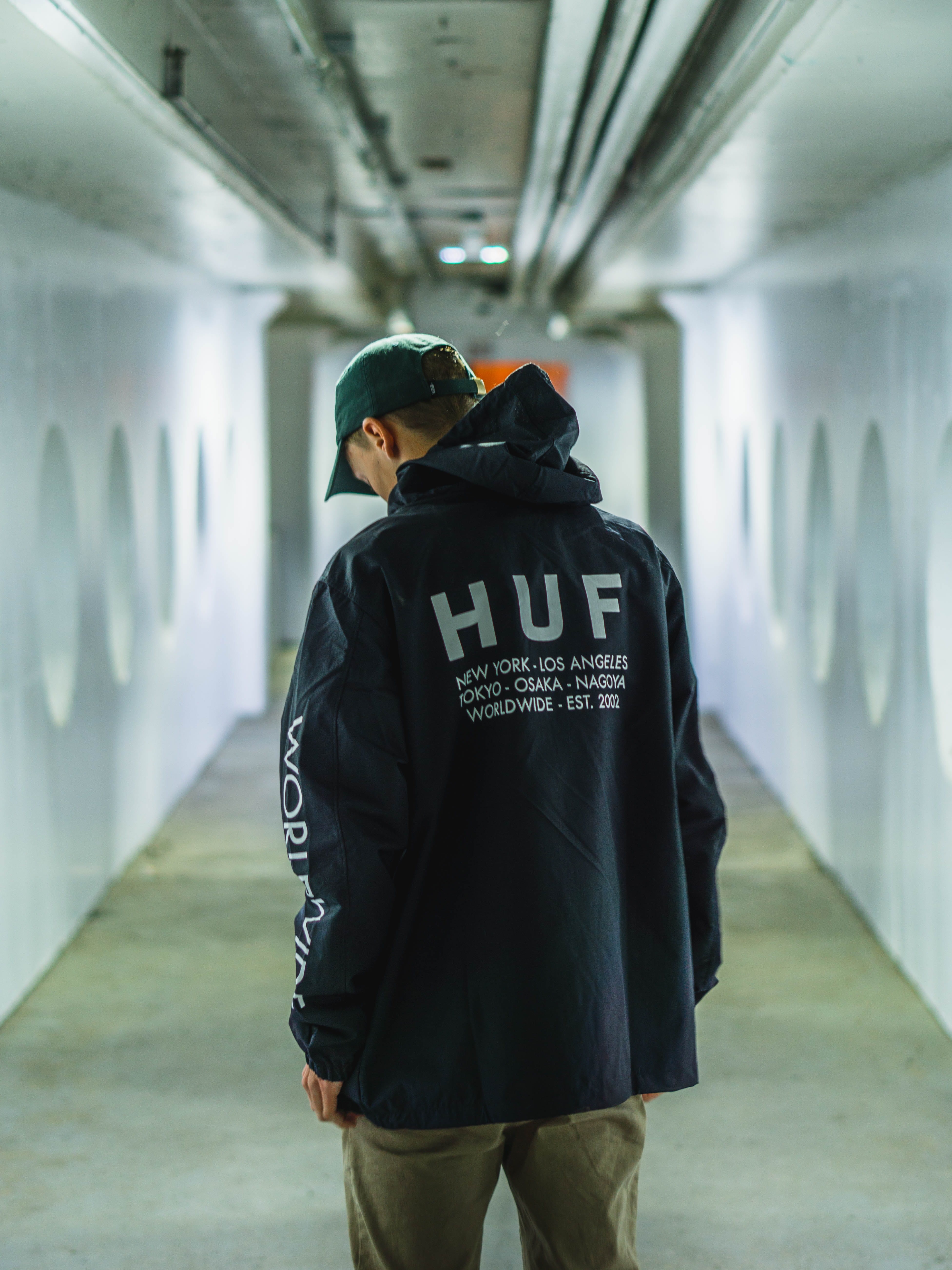subway, building, sleeve, focus on foreground, arcade, text, coat, apparel, human, person, warm clothing, pants, people, casual clothing, overcoat, portrait, Phone HD Wallpaper