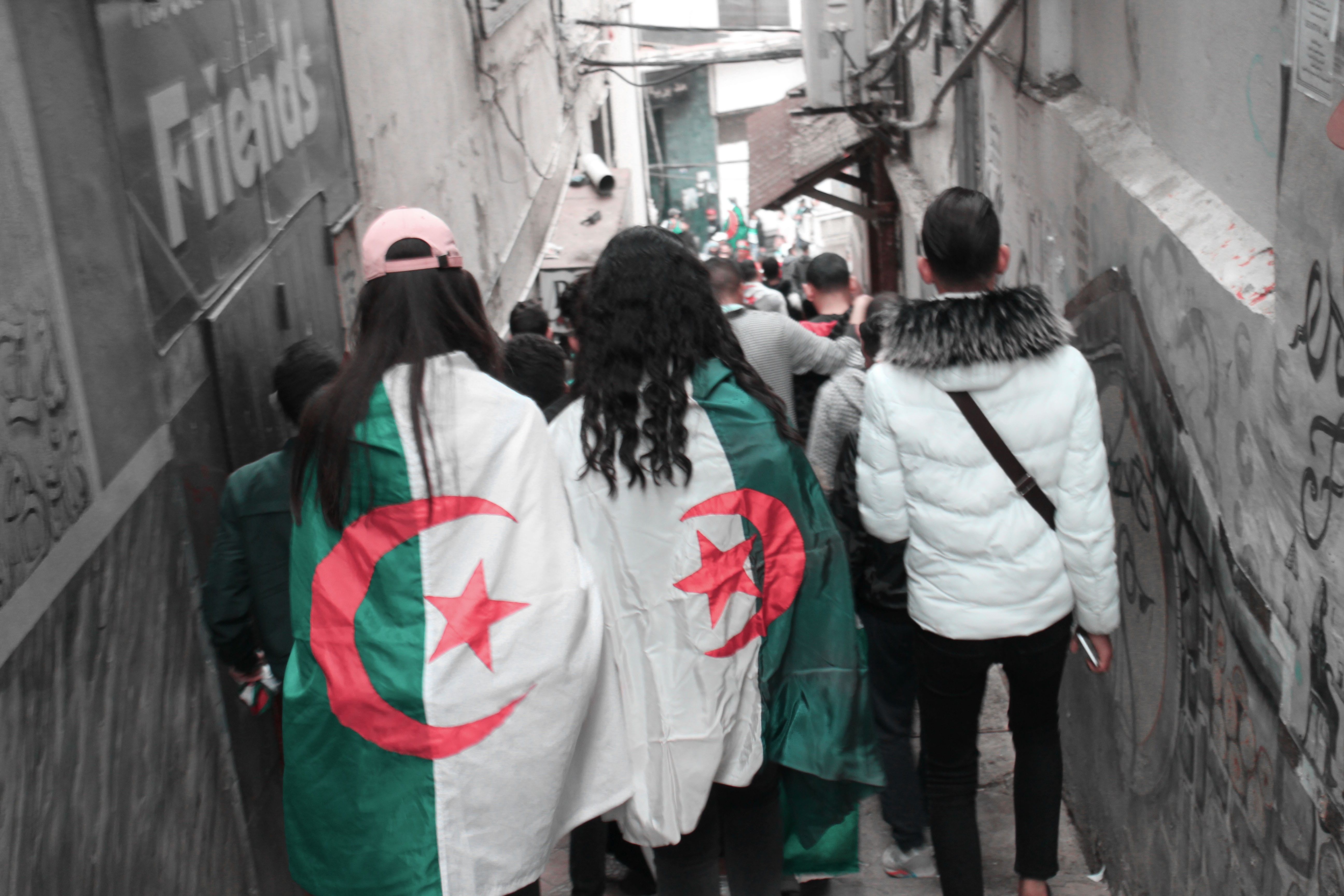 person, city life, men, hood - clothing, rear view, costume, graffiti, street, pants, women, adult, jacket, text, coat, clothing, alley, algerie, crowd, HD Wallpaper