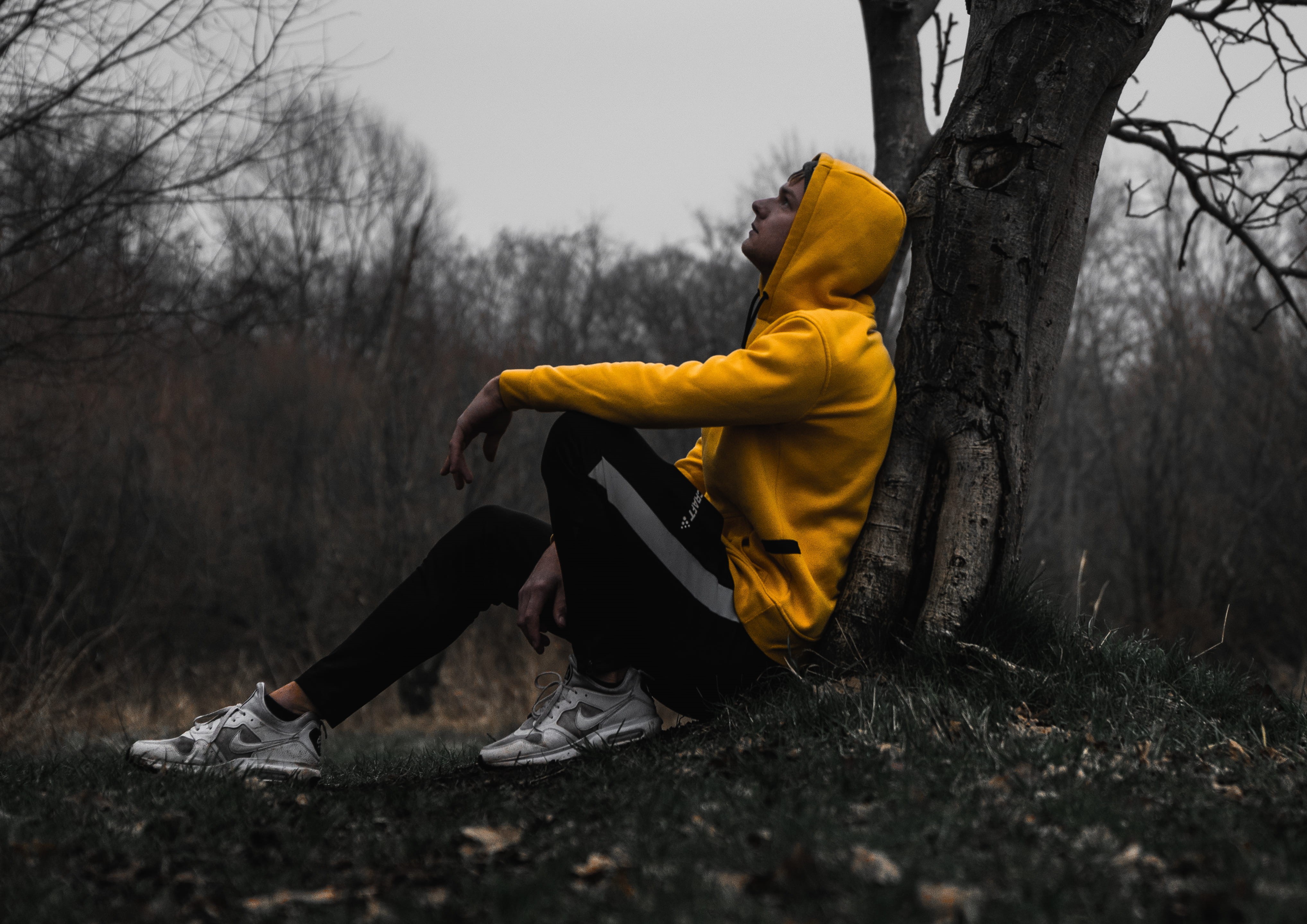 land, nature, shoe, young adult, coat, leisure activity, clothing, tree trunk, alone in nature, apparel, yellow, sad, outdoors, ground, raincoat, one person, HD Wallpaper