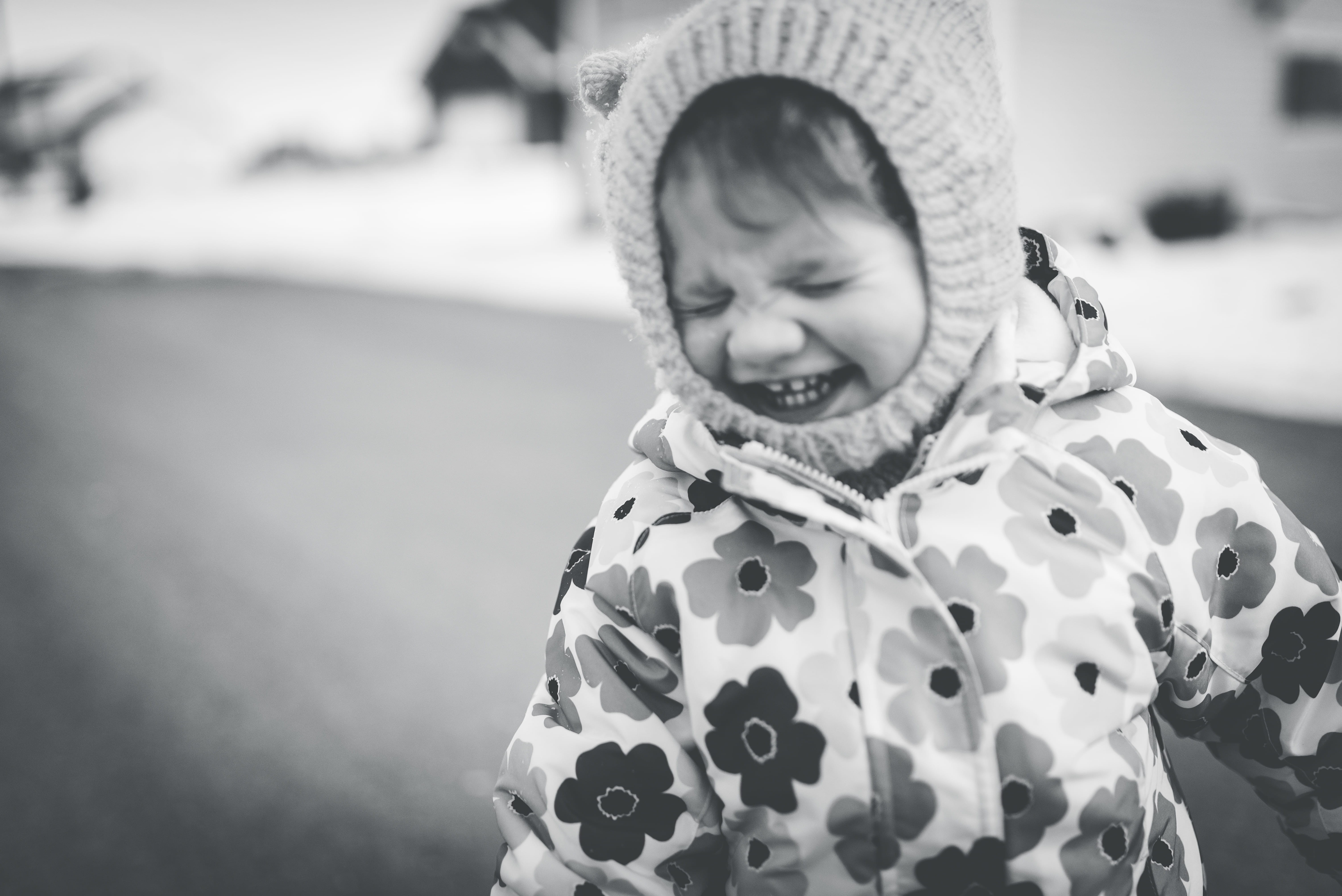 child, toddler, raincoat, warm clothing, portrait, human, winter, happiness, black and white, clothing, apparel, hoodie, outdoors, face, smiling, bonnet, HD Wallpaper