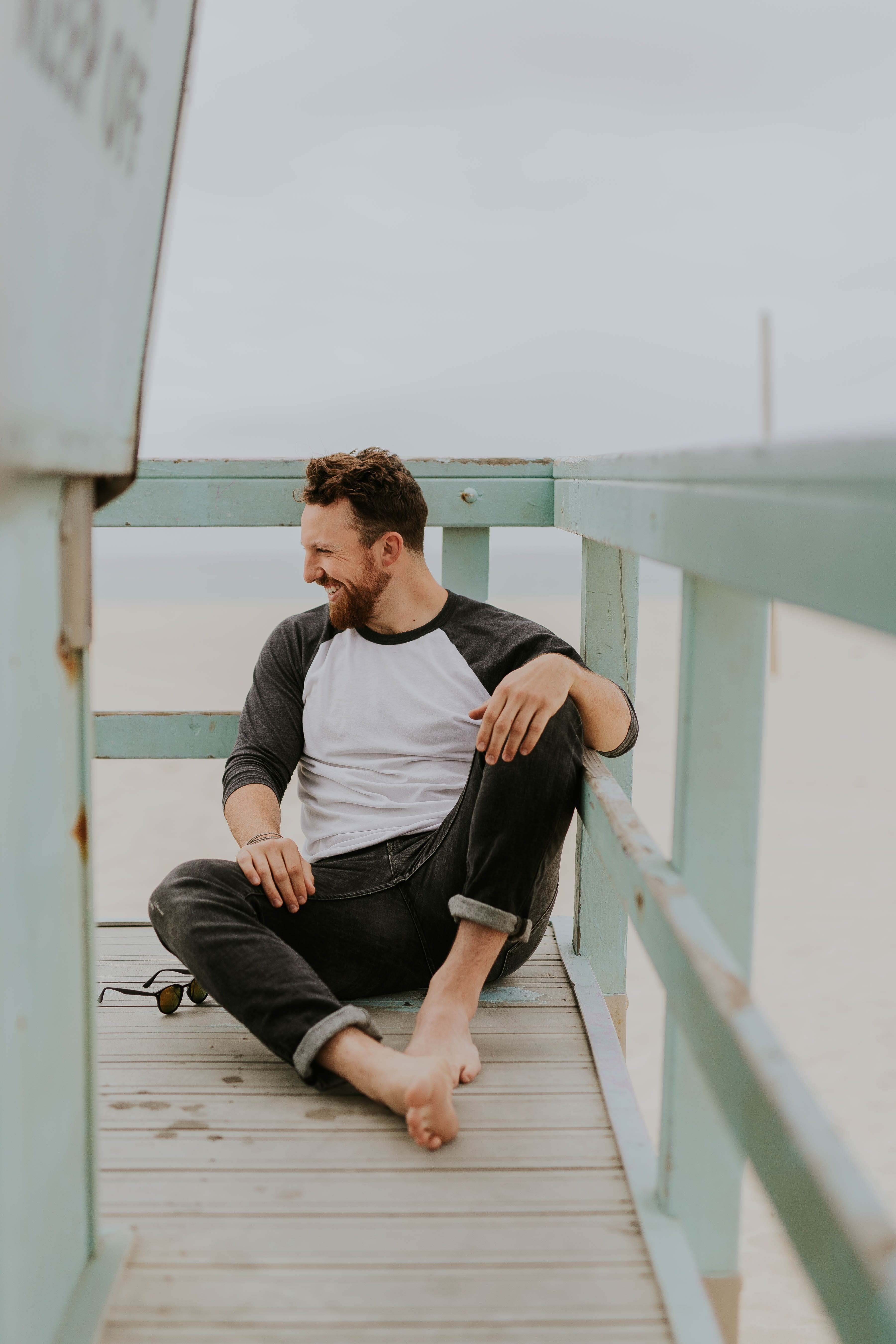 white, smiling, daytime, young Adult, laugh, sleeved, young Men, contemplation, pier, leisure activity, lifestyles, brown hair, floor, shirt, sitting, one Man Only, Phone HD Wallpaper