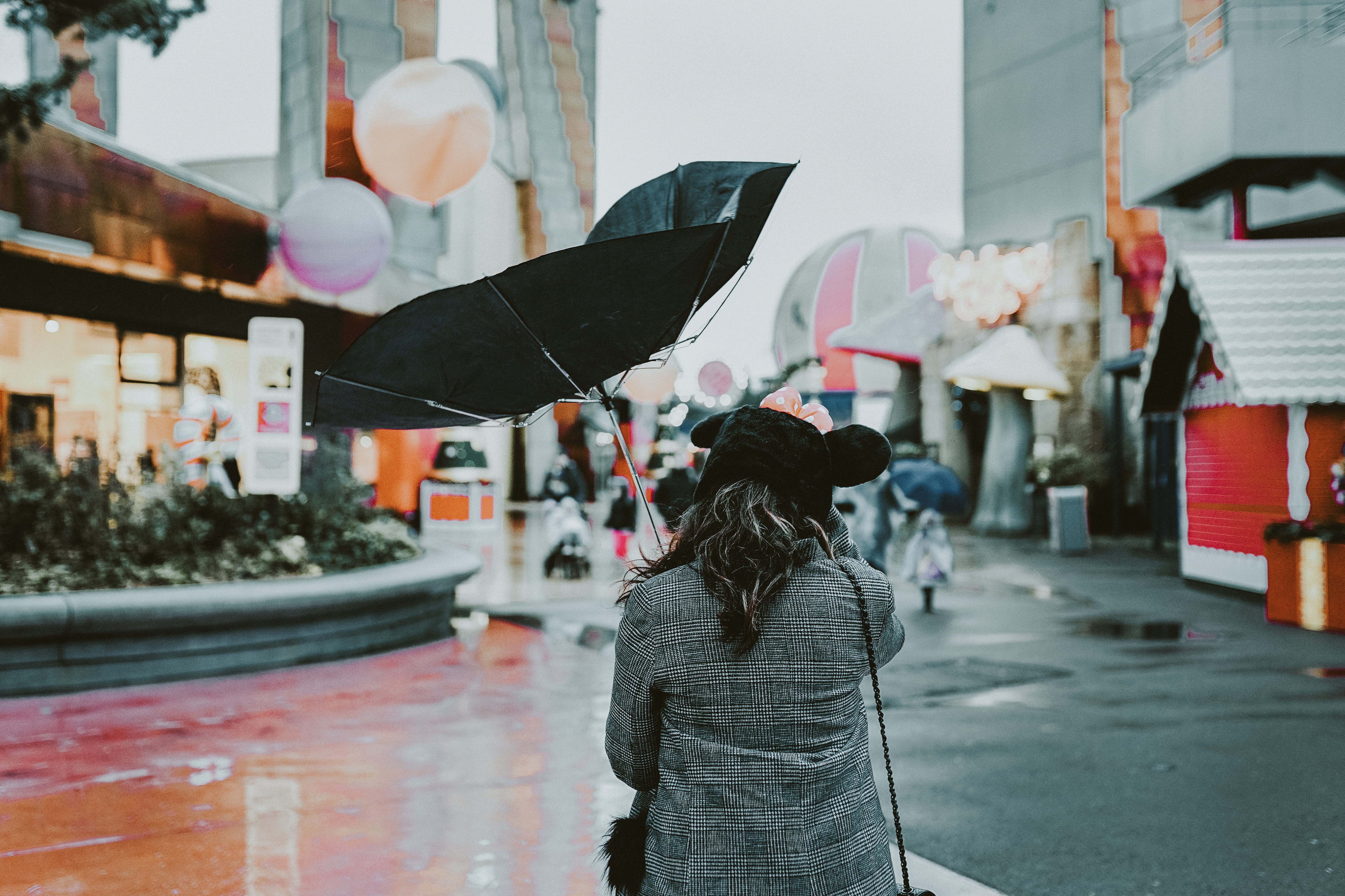 woman, incidental people, umbrella, near, holding, open, rear view, hairstyle, real people, warm clothing, women, city, windy, outdoors, building exterior, HD Wallpaper