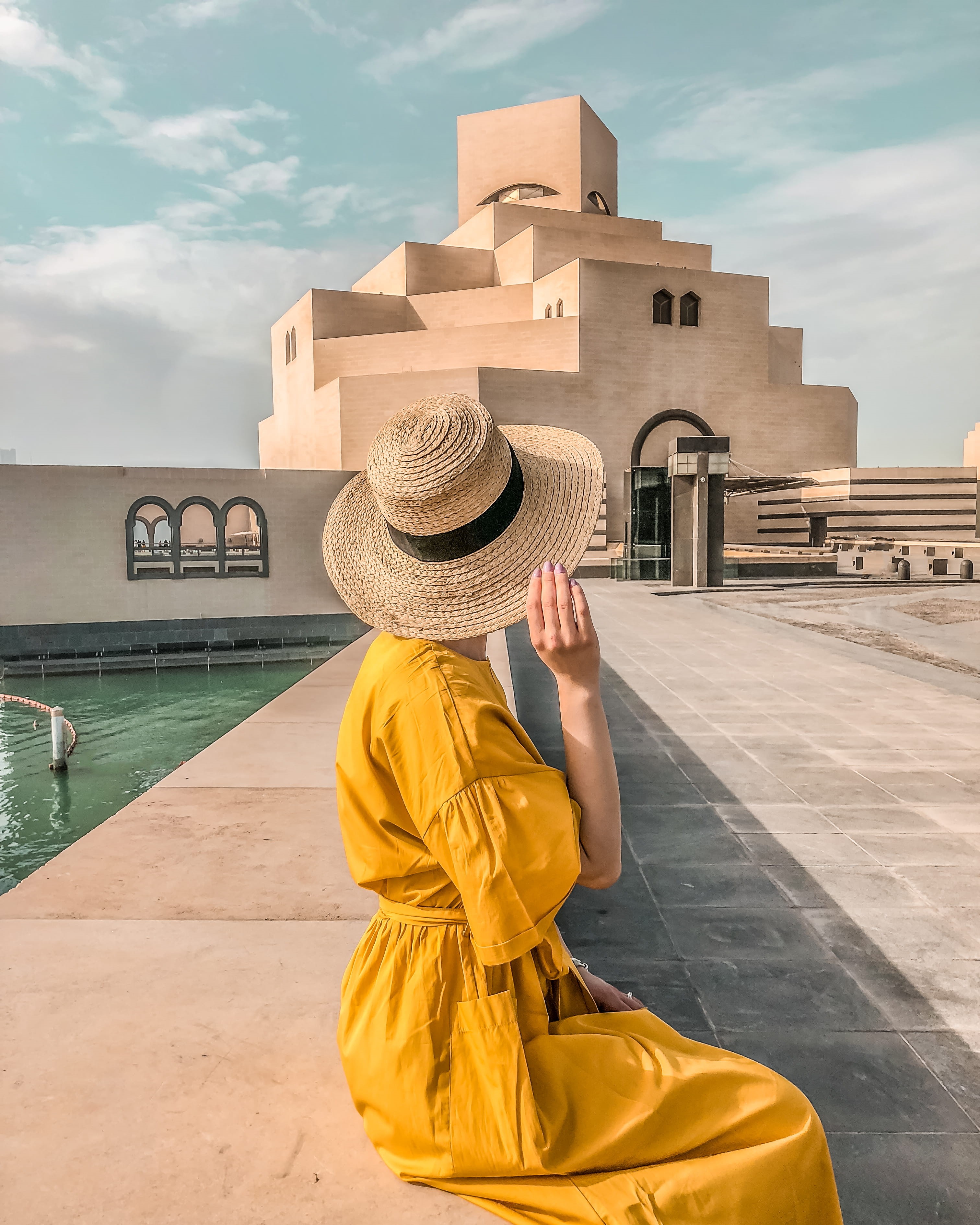 human, qatar, one person, women, yellow, people, sky, obscured face, building exterior, building, doha, museum of islamic art, built structure, outdoors, Phone HD Wallpaper