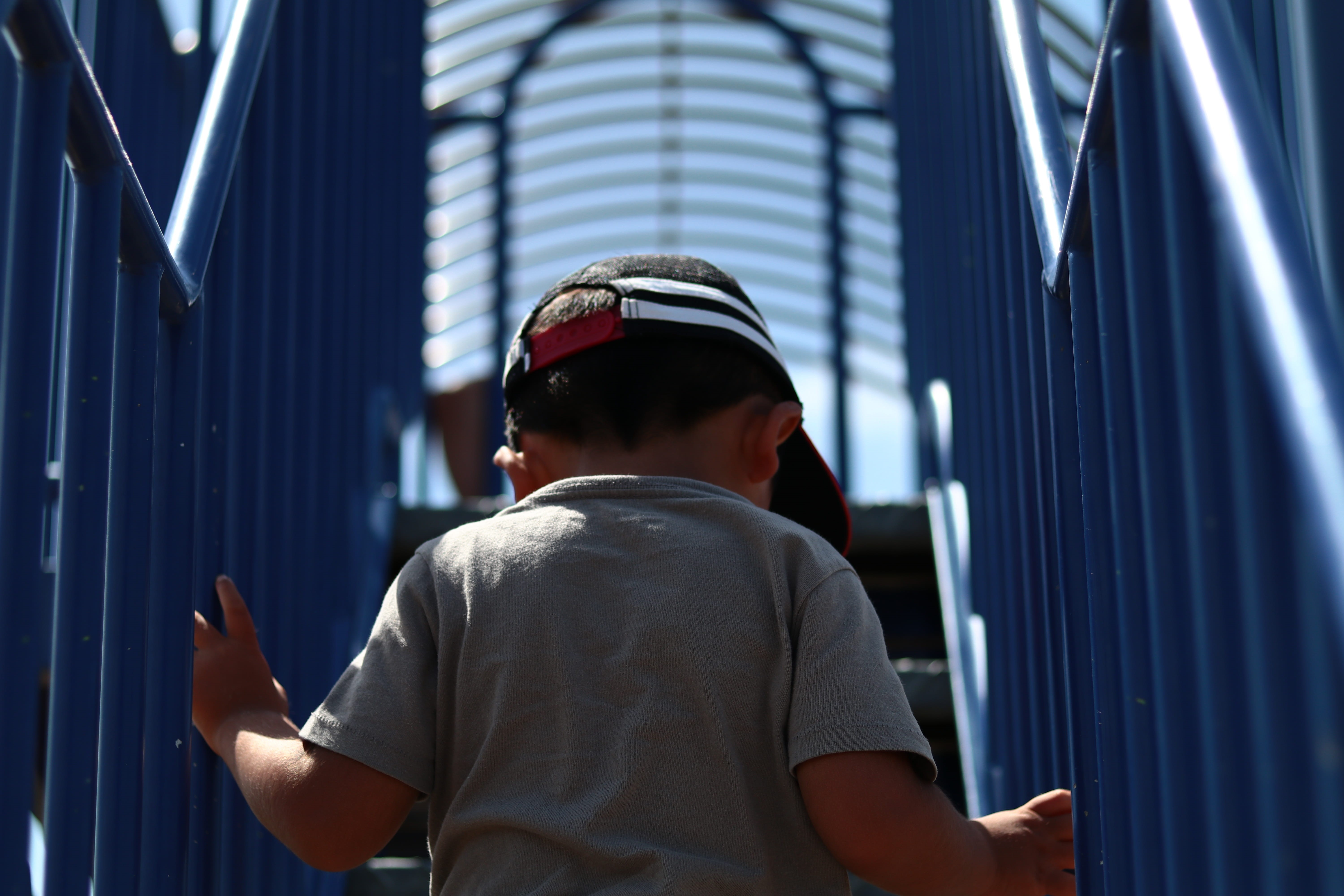 built structure, males, handrail, childhood, park, portrait, cap, one person, waist up, sunny, adventure, real people, stairs, rear view, outdoors, sky, HD Wallpaper