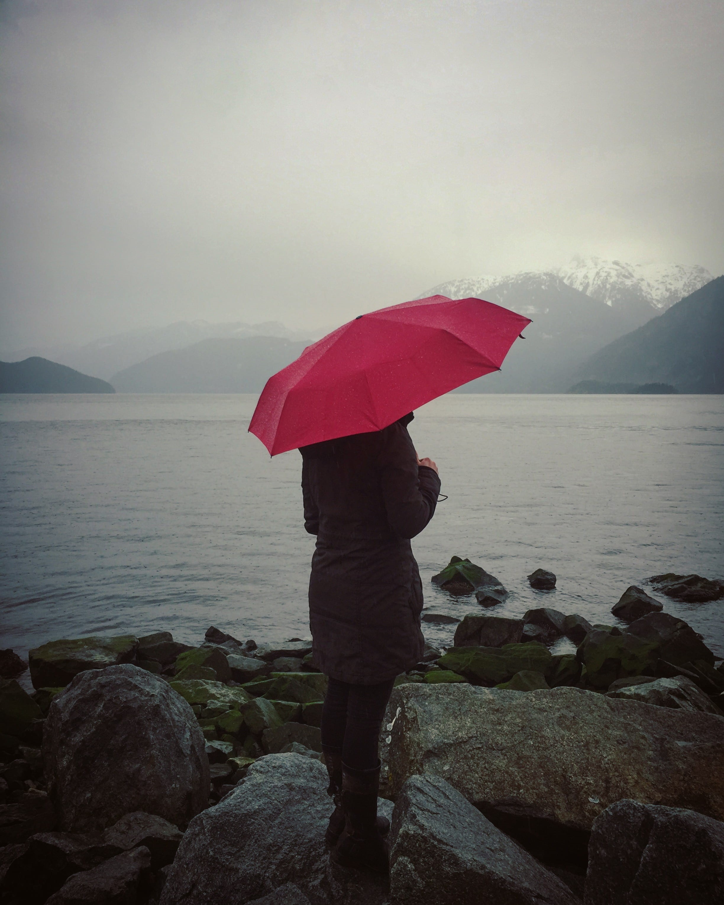 sky, tranquility, looking at view, mountain, beauty in nature, looking out, grey, outdoors, solitude, protection, rear view, body, rain, 2K, snow, rock - object, Phone HD Wallpaper
