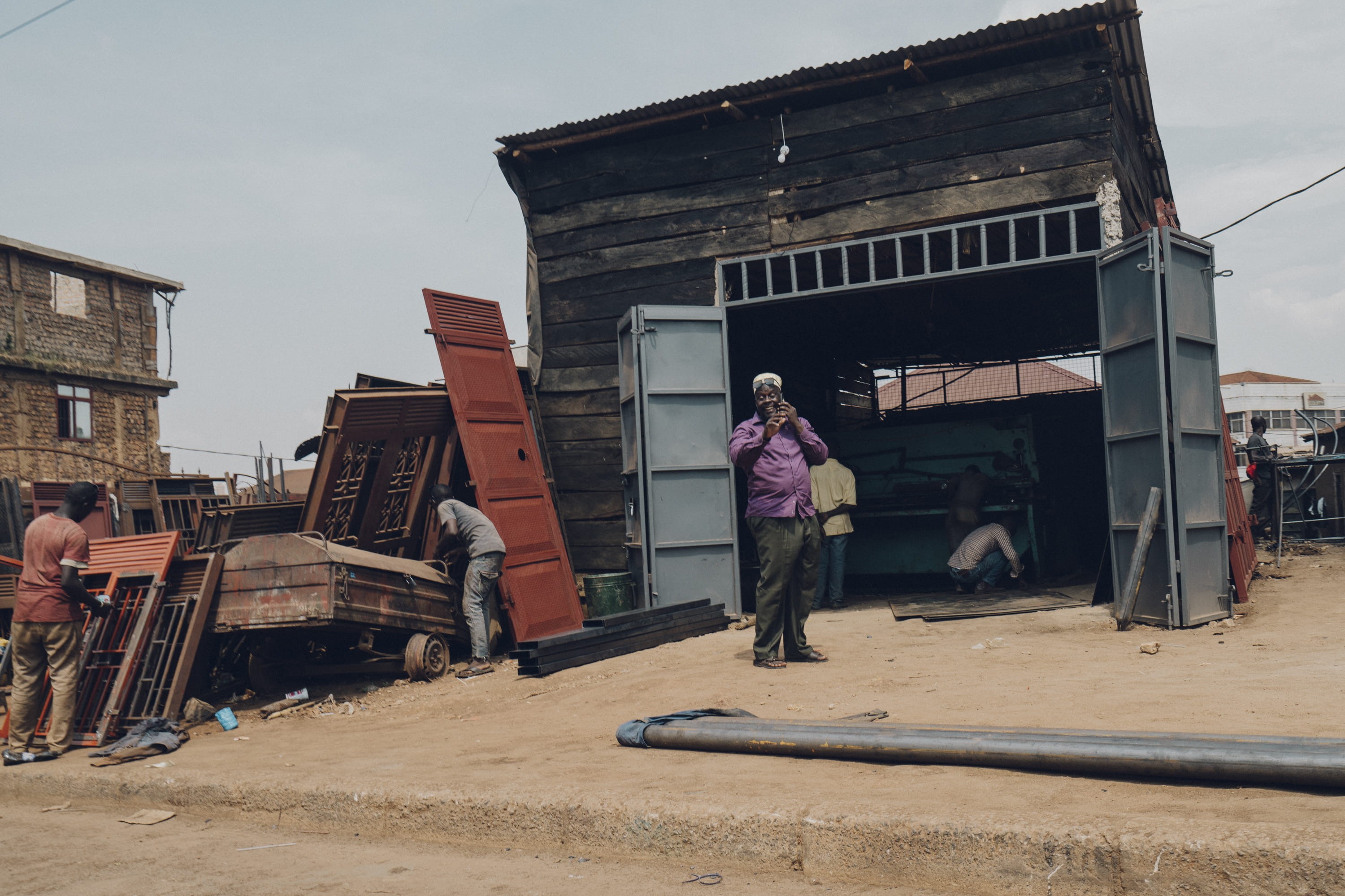 one person, streetview, rural, building exterior, phone, person, africa, city, women, clothing, human, sky, housing, standing, day, 2K, countryside, transportation, HD Wallpaper
