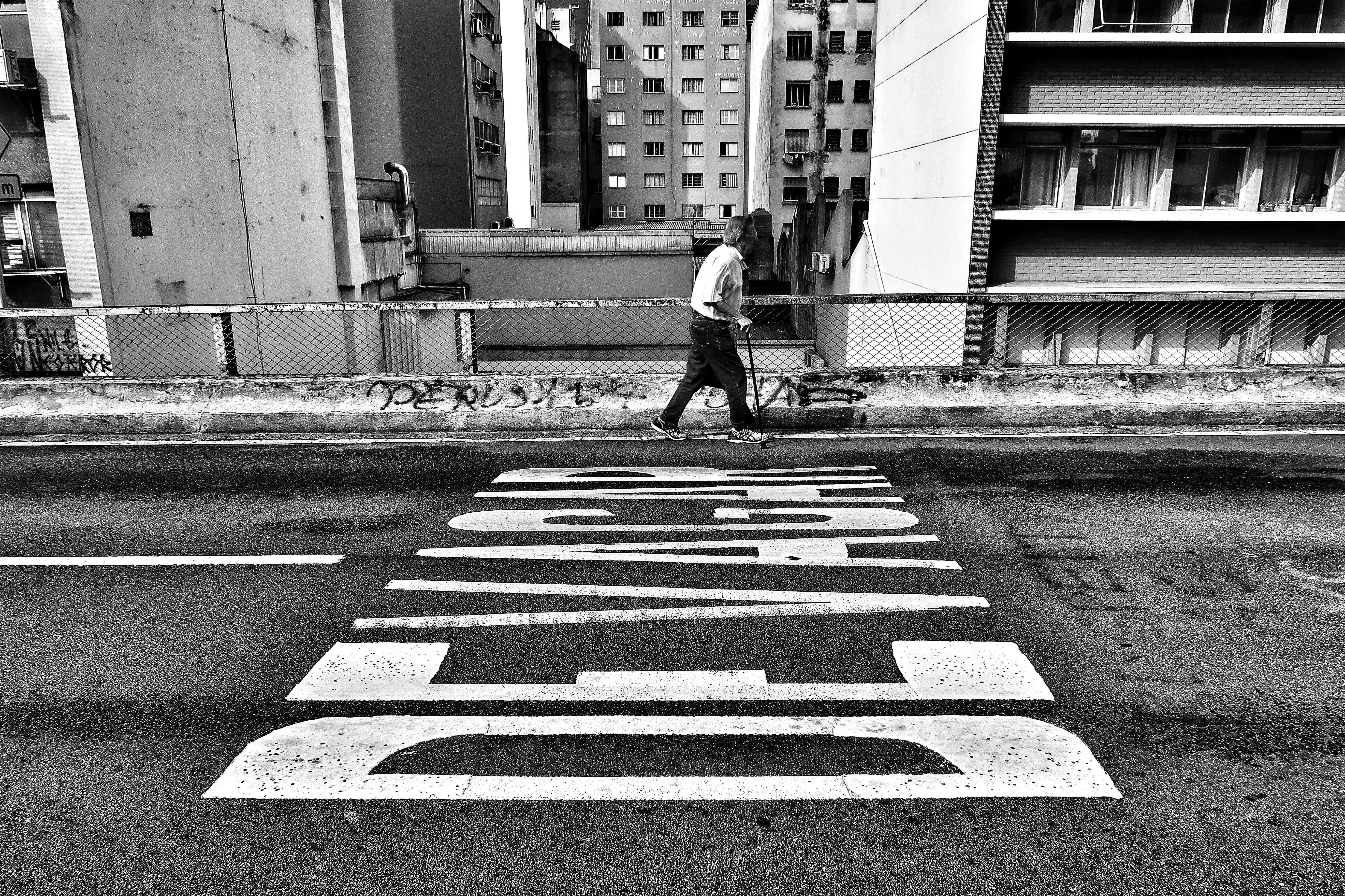 outdoors, crossing, monochrome, symbol, beside, building exterior, photography, walking, men, gray, slowly, person, road, sign, transportation, crosswalk, HD Wallpaper