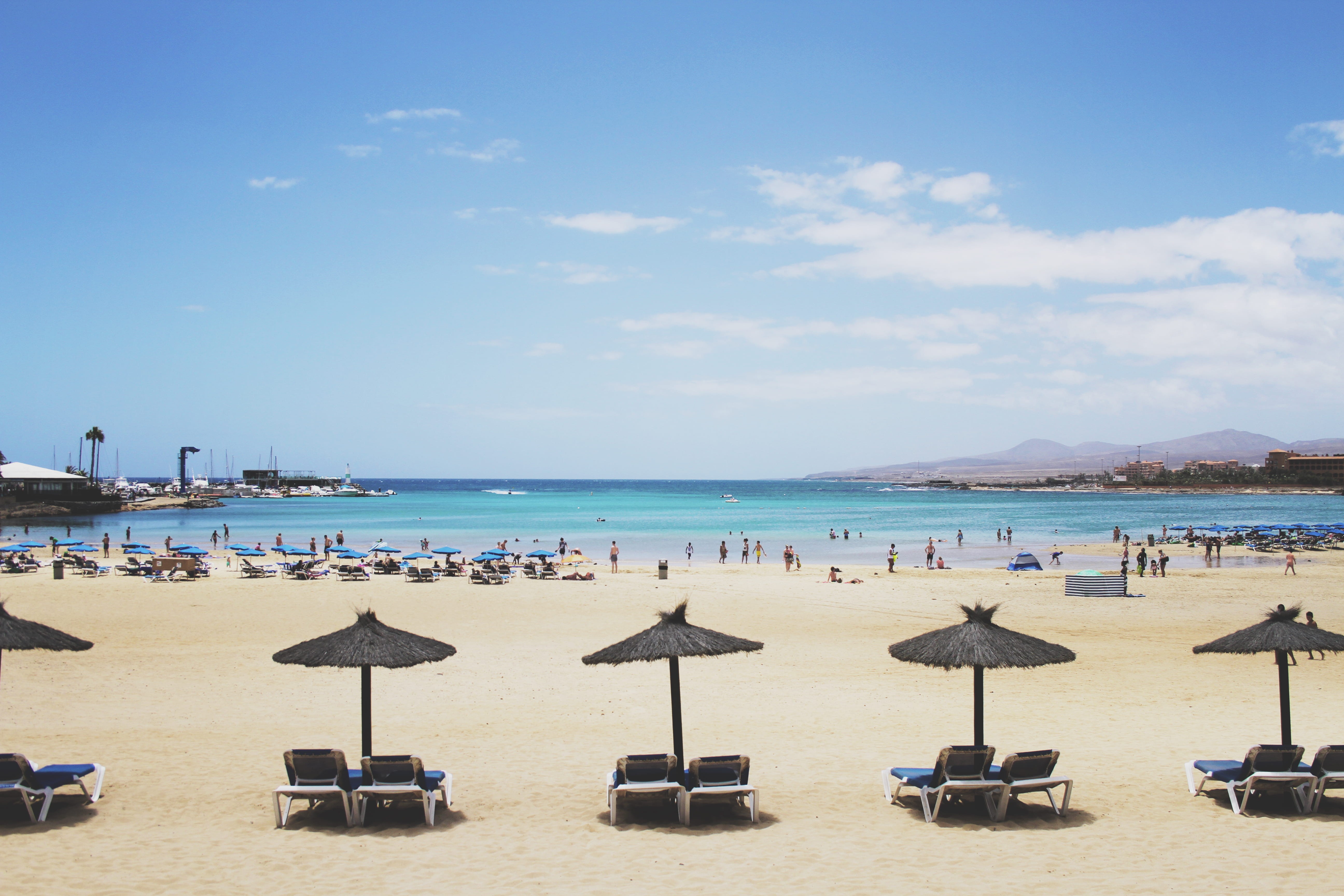 canary islands, beach, chair, land, holiday, horizon over water, sky, incidental people, umbrella, beauty in nature, 5K, spain, day, cloud - sky, caleta de fuste beach, HD Wallpaper