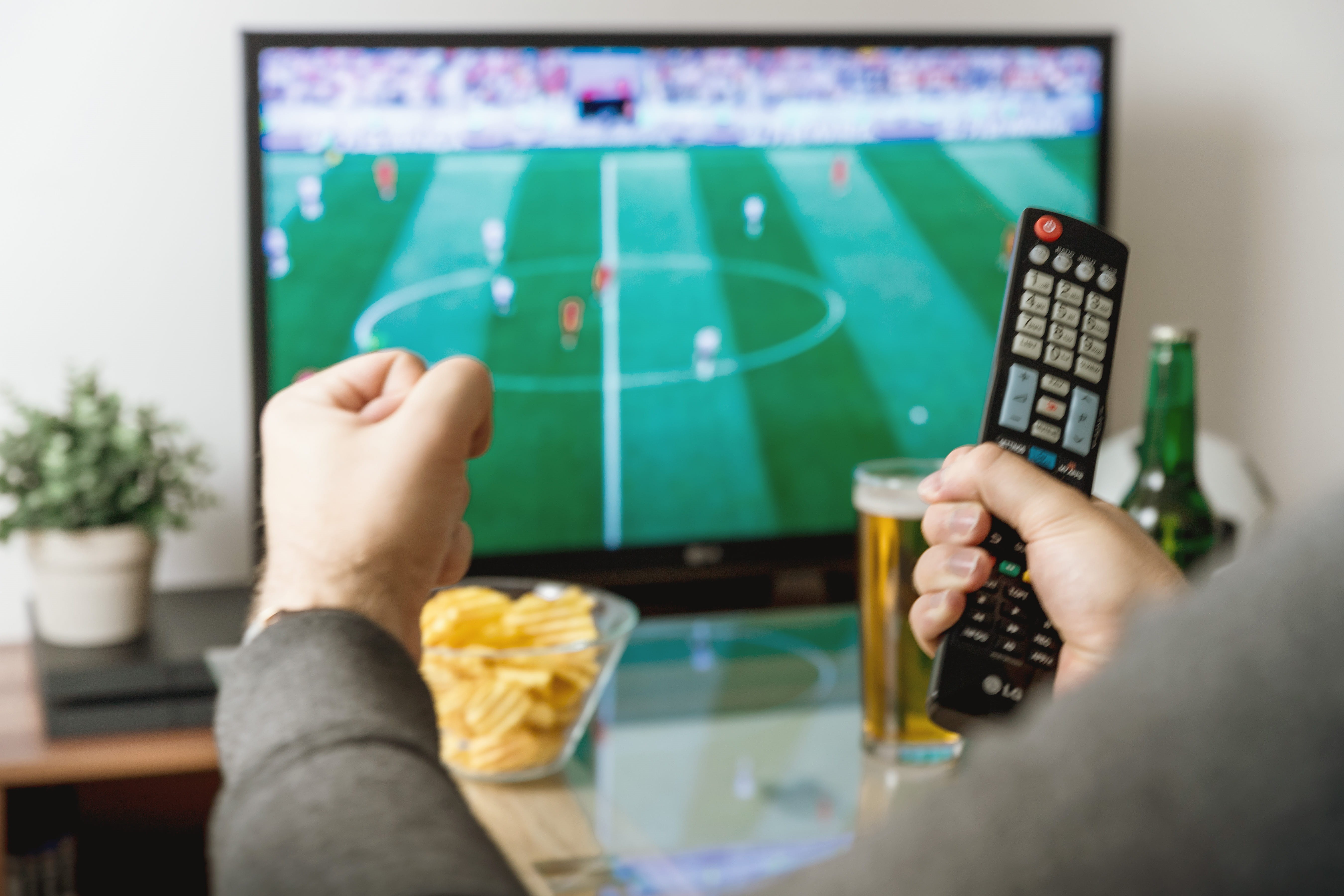 hand, indoors, watching, remote, football, controller, adult, close-up, team sport, sport, television set, leisure activity, relaxation, 5K, domestic room, HD Wallpaper