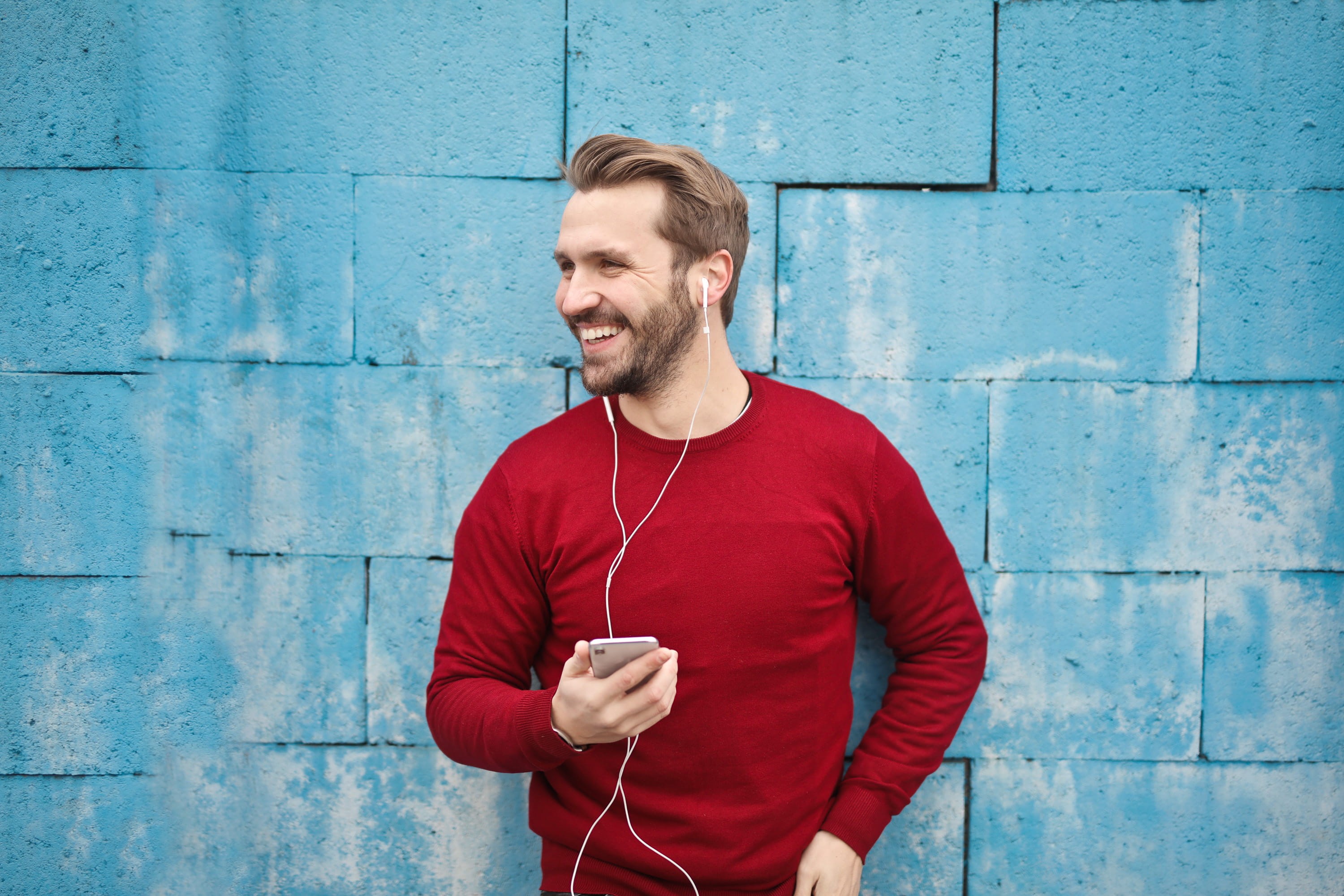 headphones, Cable, 30-35 years old, arts culture and entertainment, facial hair, travel, turquoise bricks wall, black pants, street, caucasian, male, technology, HD Wallpaper