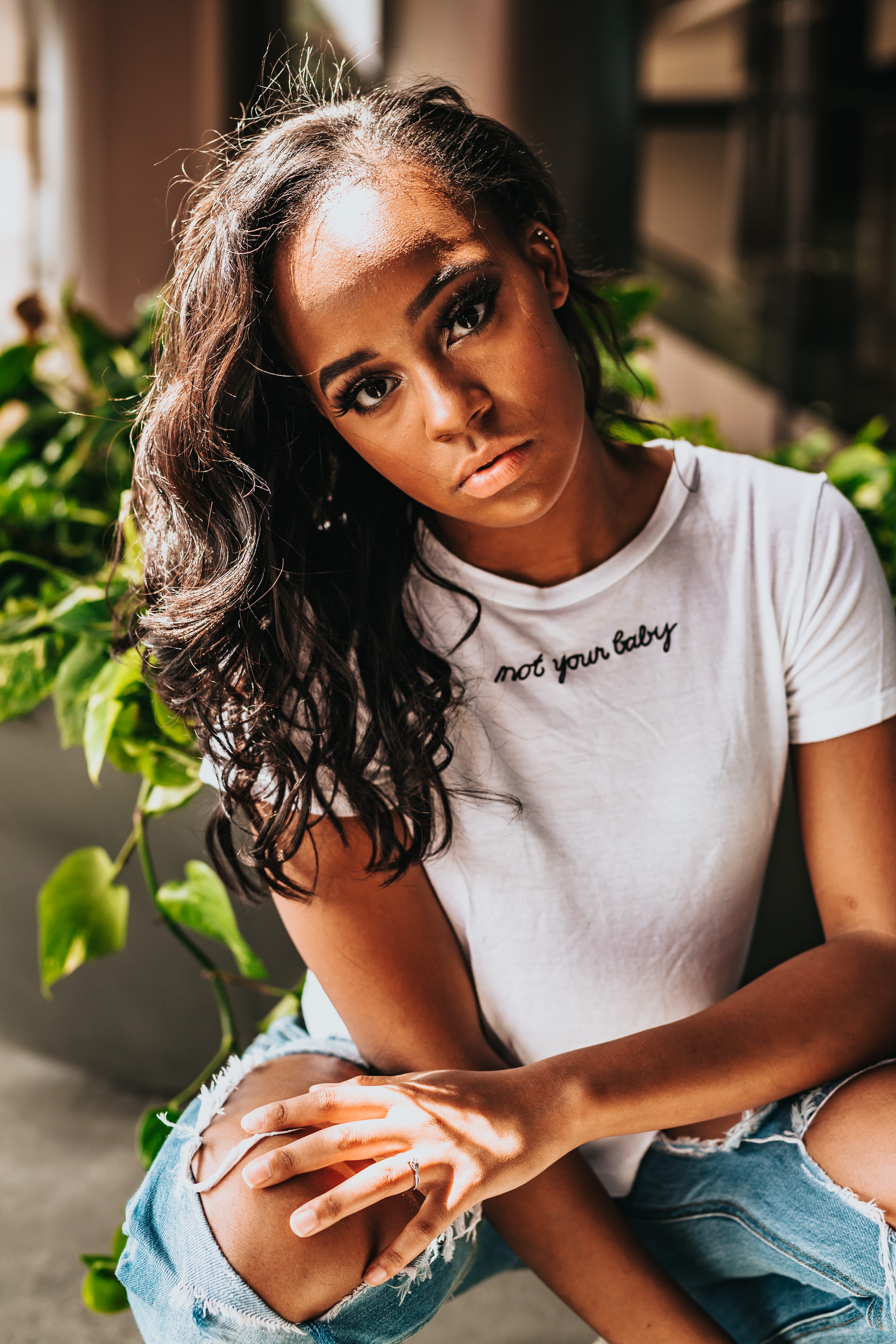 rebel, photo, bottoms, crouch, leafed, green, day, t, wearing, outdoors, african american, plant, distressed, front view, holding, one person, shirt, focus on foreground, Phone HD Wallpaper