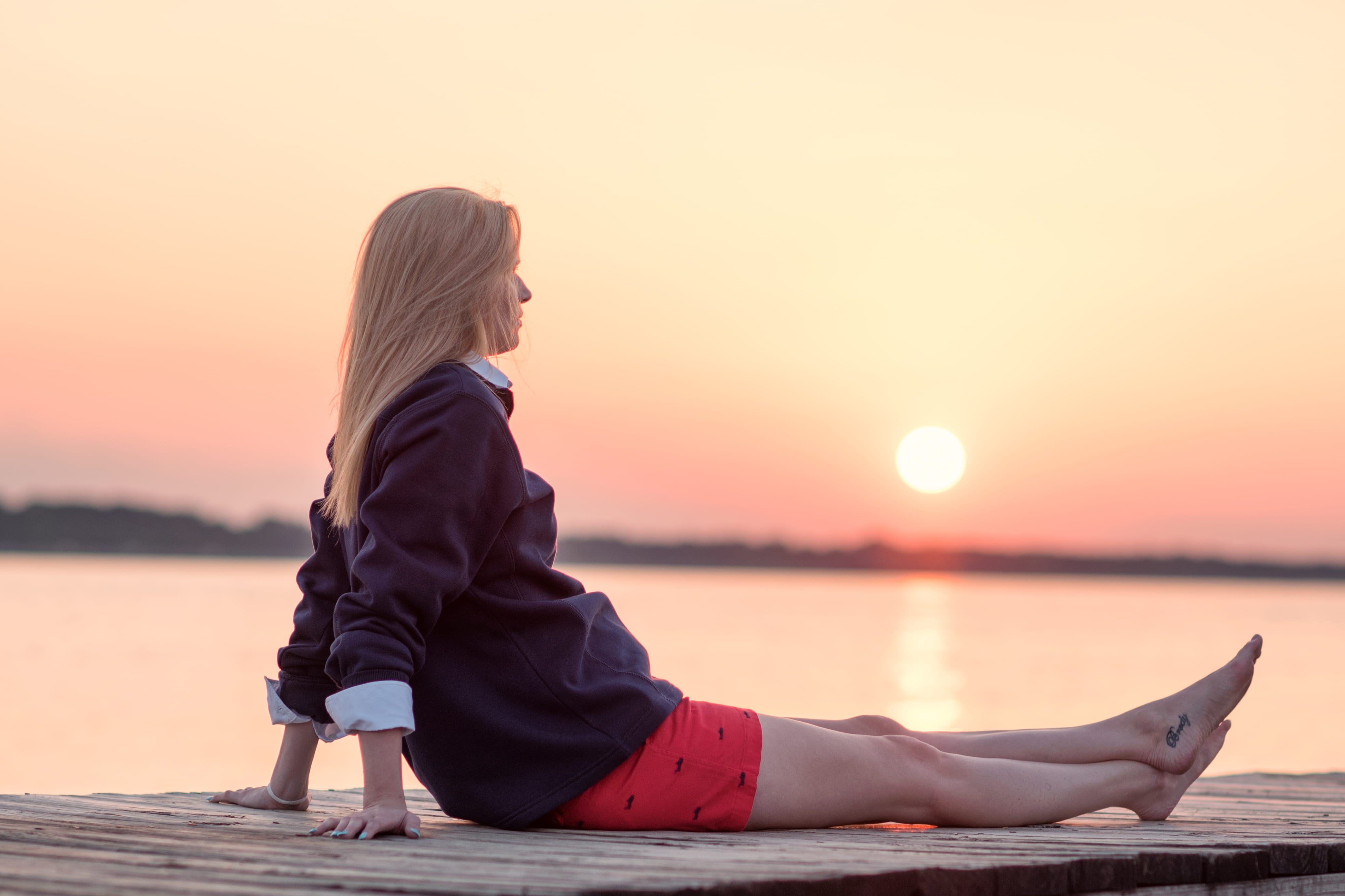 orange color, hairstyle, dusk, sitting, tranquility, girl, 4K, beauty in nature, jackson, lake, outdoors, one person, shorts, adult, sky, sun, tranquil scene, HD Wallpaper