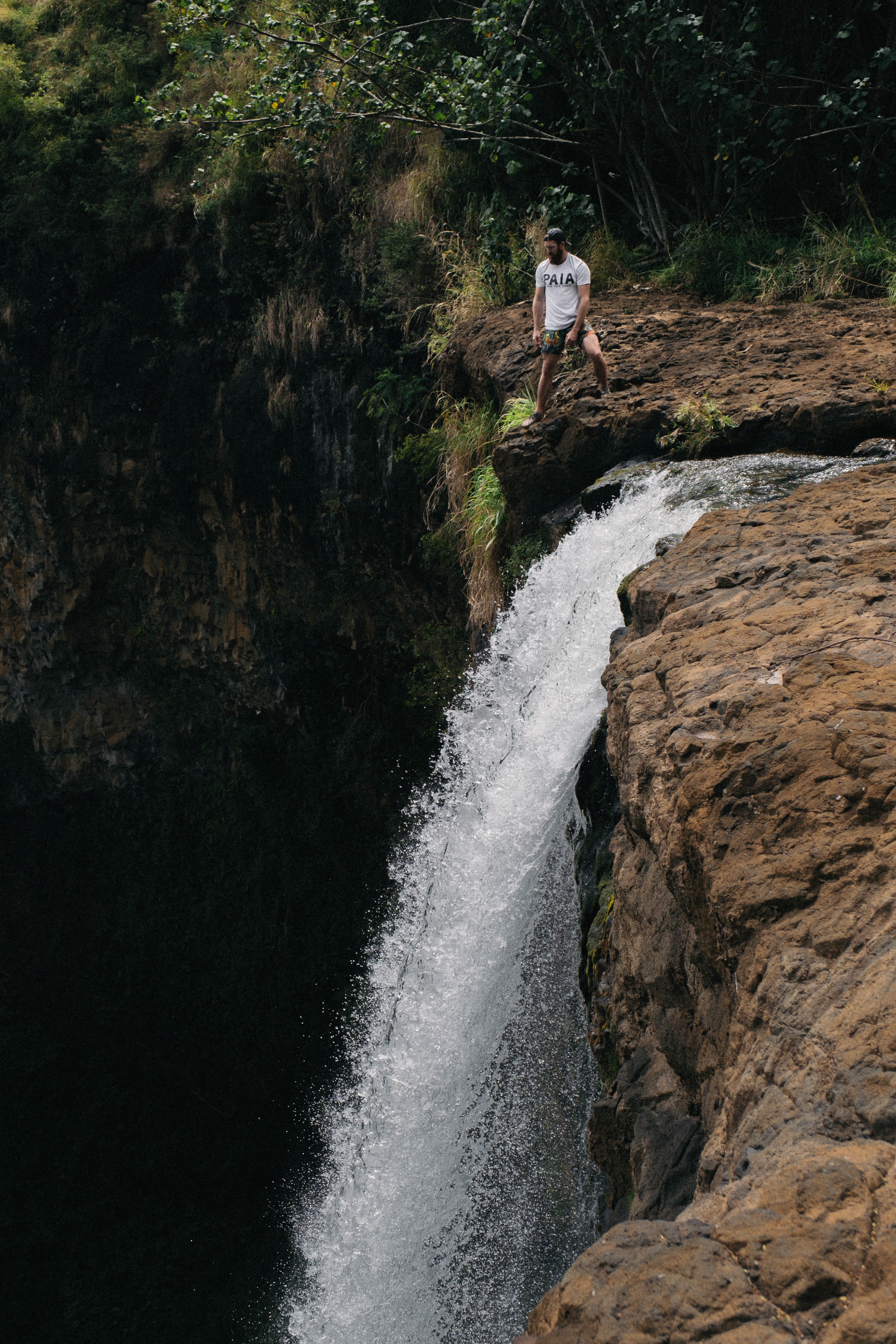 solid, atop, real people, person, waterfall, tree, outdoors, forest, one person, rock - object, beauty in nature, water, 5K, day, scenics - nature, nature, Phone HD Wallpaper