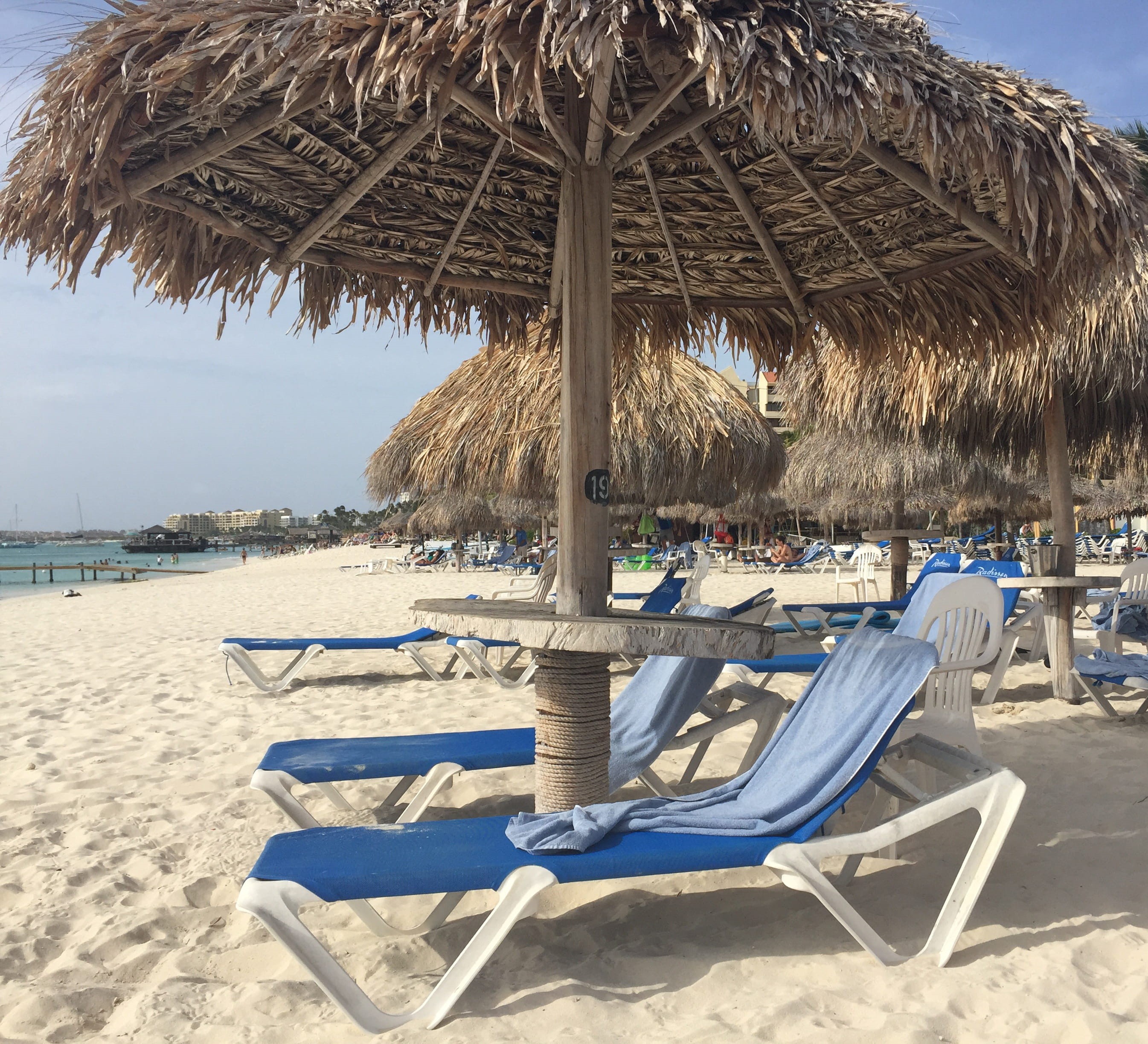 aruba, thatched roof, vacation, sand, day, shade, no people, palapa, tranquility, beach umbrella, beauty in nature, sea, outdoors, beach, roof, water, 2K, HD Wallpaper