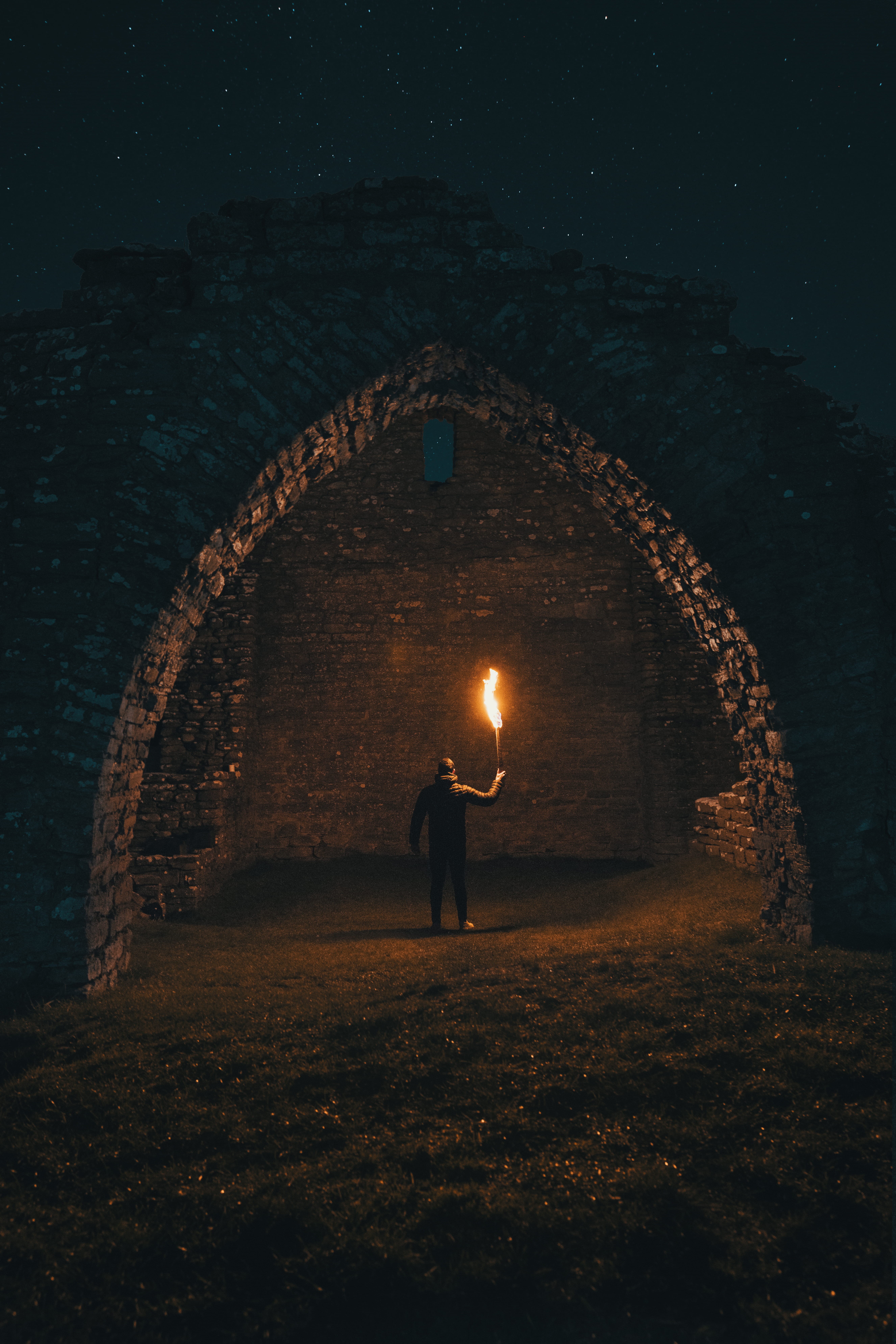 dark, full length, nature, arch, inside, illuminated, the past, built structure, carrying, tunnel, person, real people, one person, arc, torch, shaped, Phone HD Wallpaper