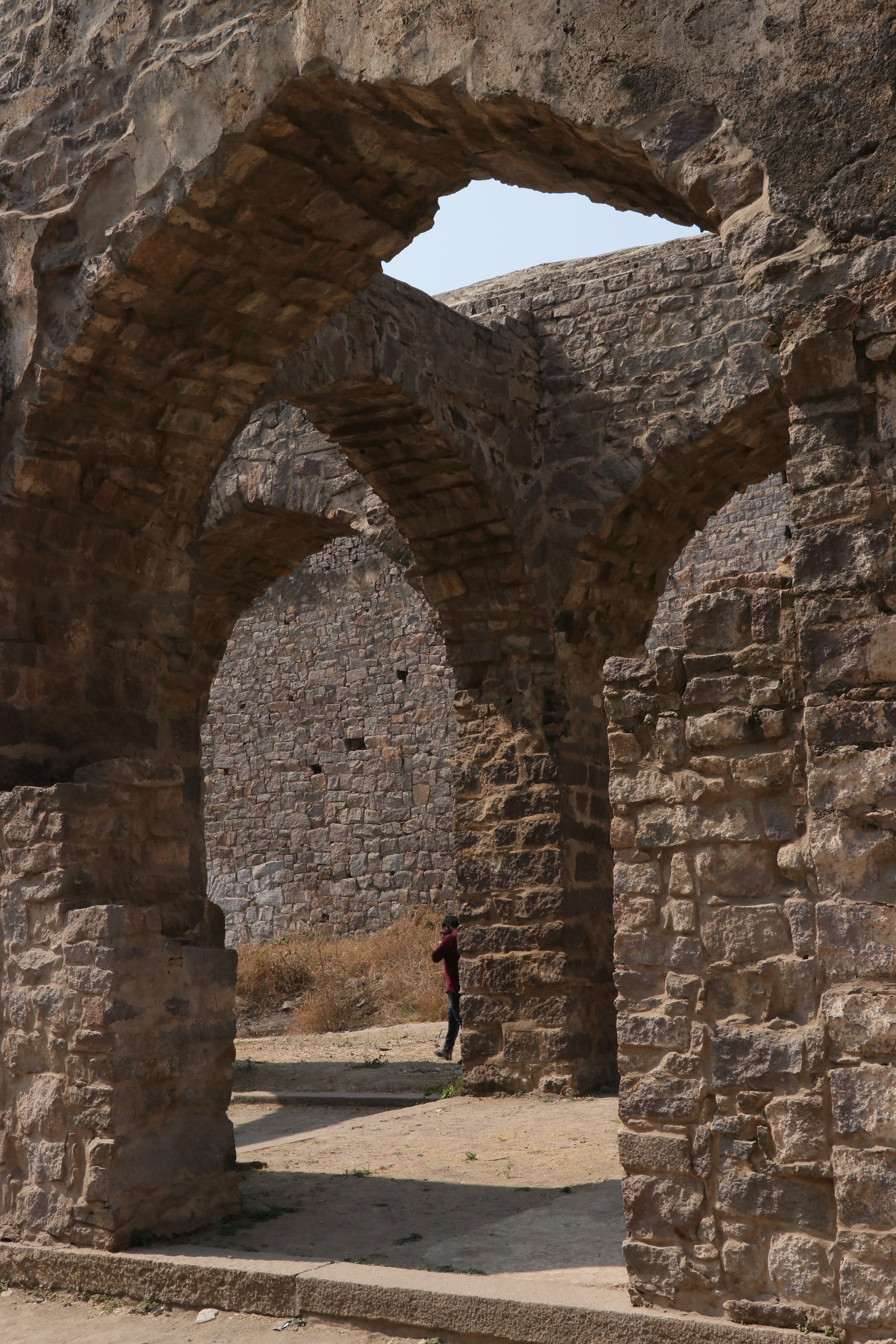 india, lifestyles, arch, leisure activity, architecture, one person, stone wall, hyderabad, built structure, old ruin, full length, tourism, ancient, sunlight, Phone HD Wallpaper