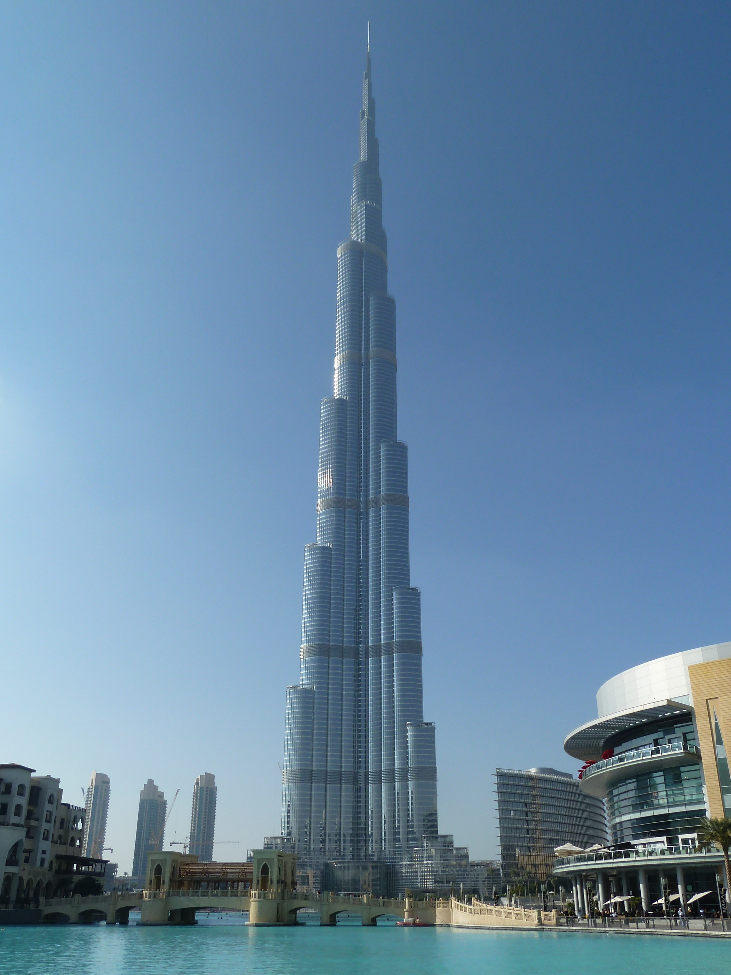 office building exterior, water, outdoors, urban Scene, famous Place, sky, modern, urban Skyline, daytime, spire, burj, dubai, khalifa, clear sky, record, Phone HD Wallpaper