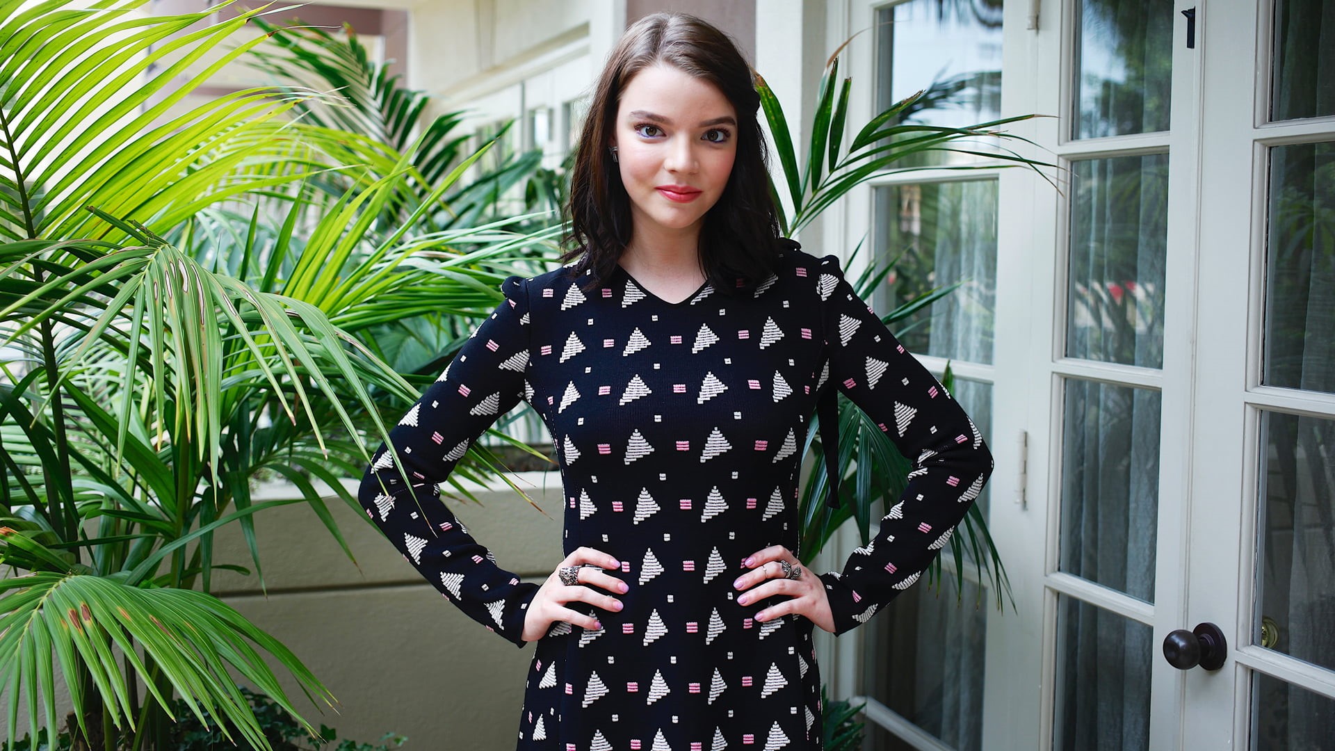 actress, brunette, plants, Anya Taylor-Joy, women outdoors, dark hair, women, 1080P, hands on hips, shoulder length hair, HD Wallpaper