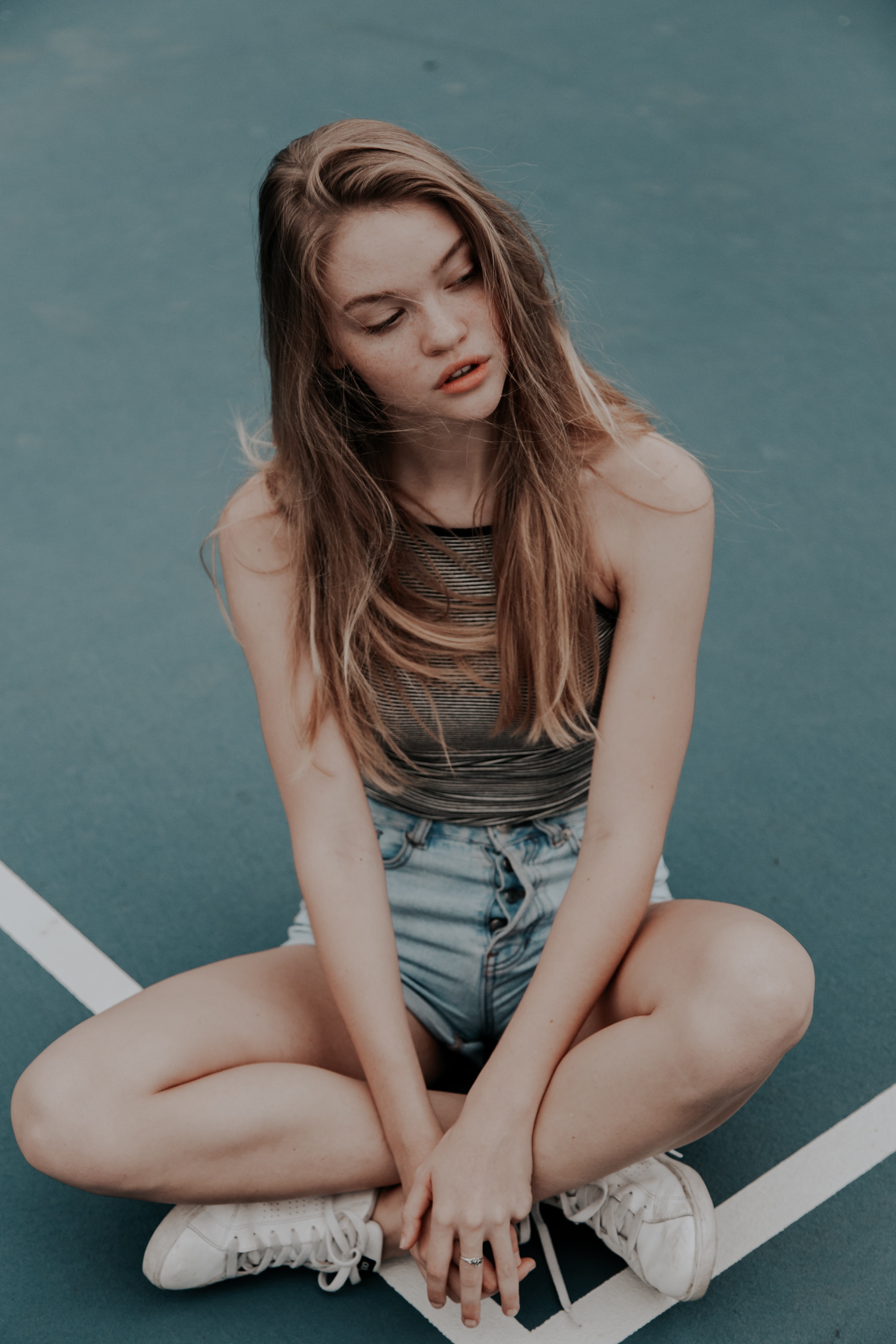 women, 5K, tank top, people, legs crossed, brunette, bare shoulders, jean shorts, sitting, freckles, closed eyes, model, long hair, Phone HD Wallpaper