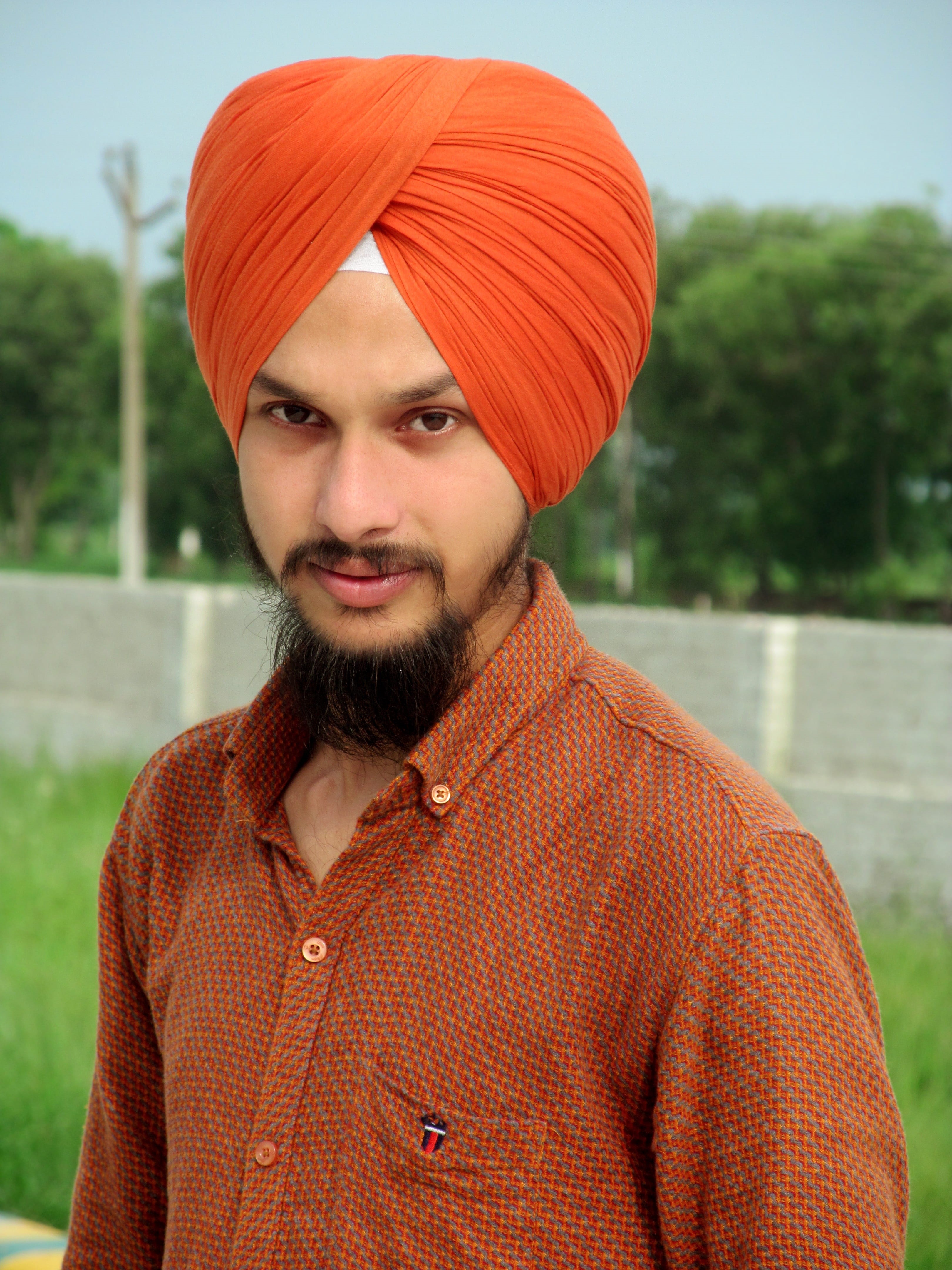 face, hat, people, sikh, one person, smile, focus on foreground, front view, sikh turban, portrait, outdoors, sikhism, male, young men, 4K, looking at camera, Phone HD Wallpaper