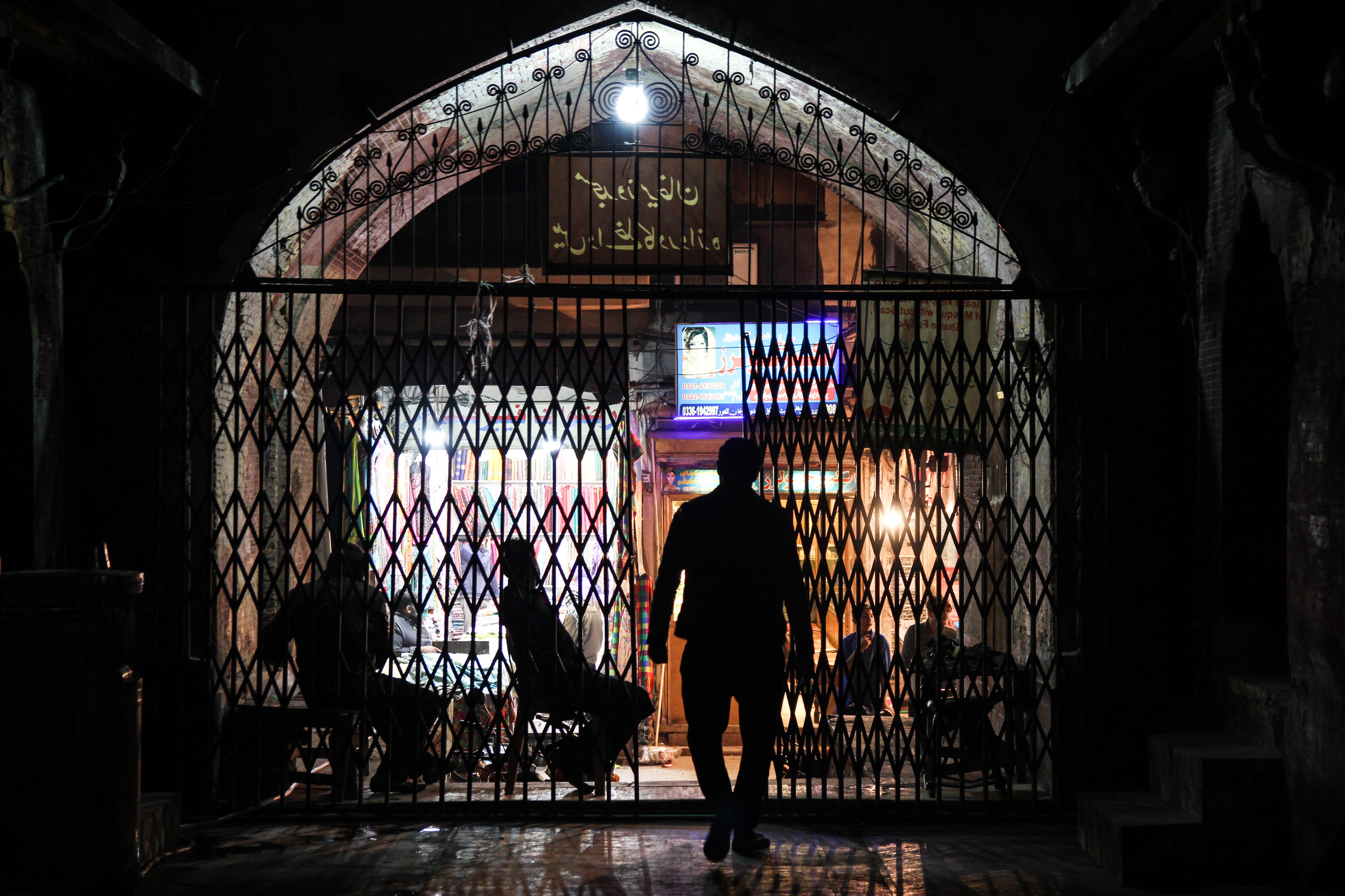one person, lahore, indoors, shadows, walking, silhouette, standing, illuminated, adult, built structure, pakistan, casual clothing, gate, lifestyles, architecture, HD Wallpaper