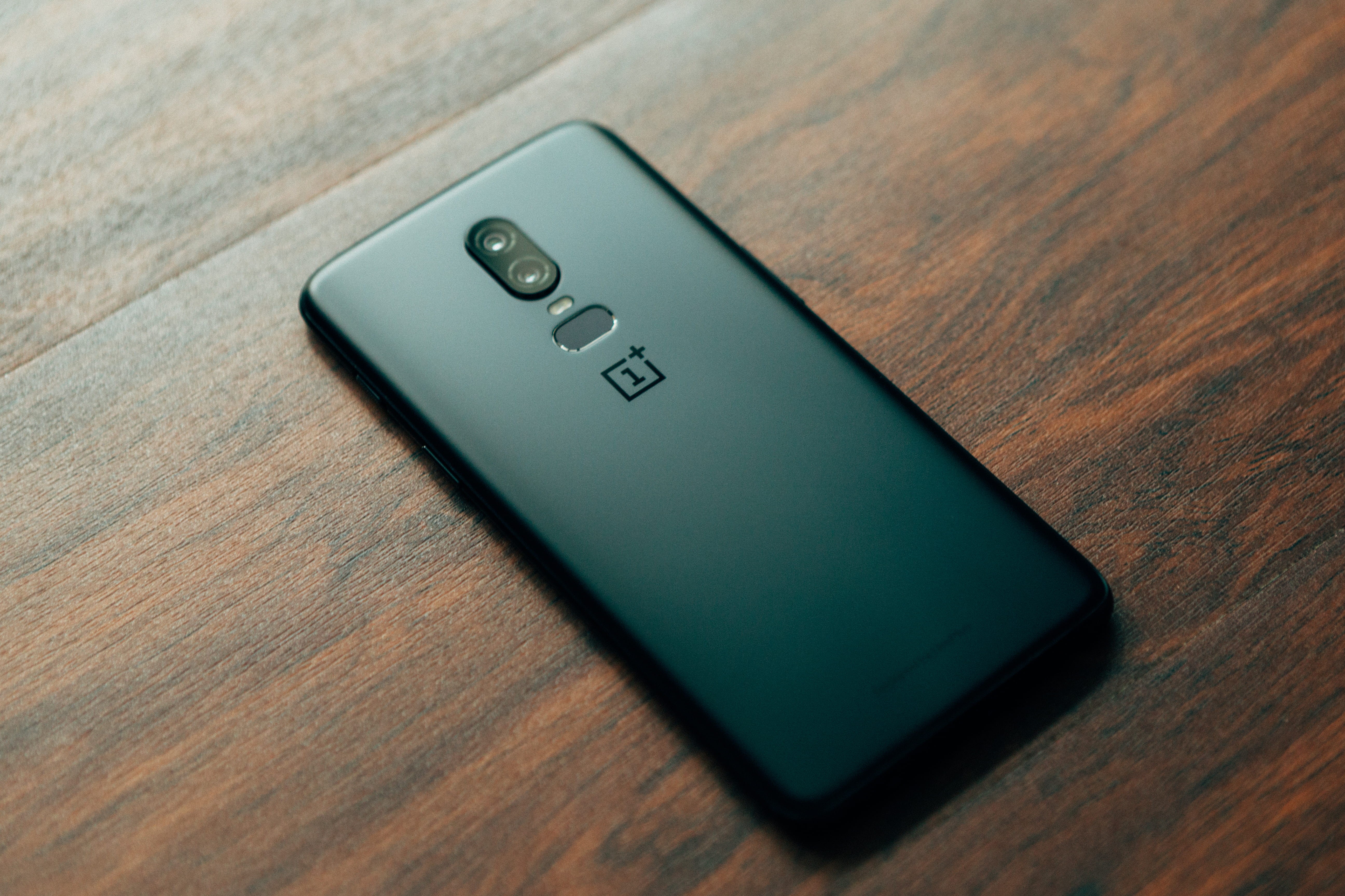 text, gadget, 5K, remote control, no people, selective focus, oneplus, wireless technology, dual camera, push button, western script, indoors, wood grain, HD Wallpaper