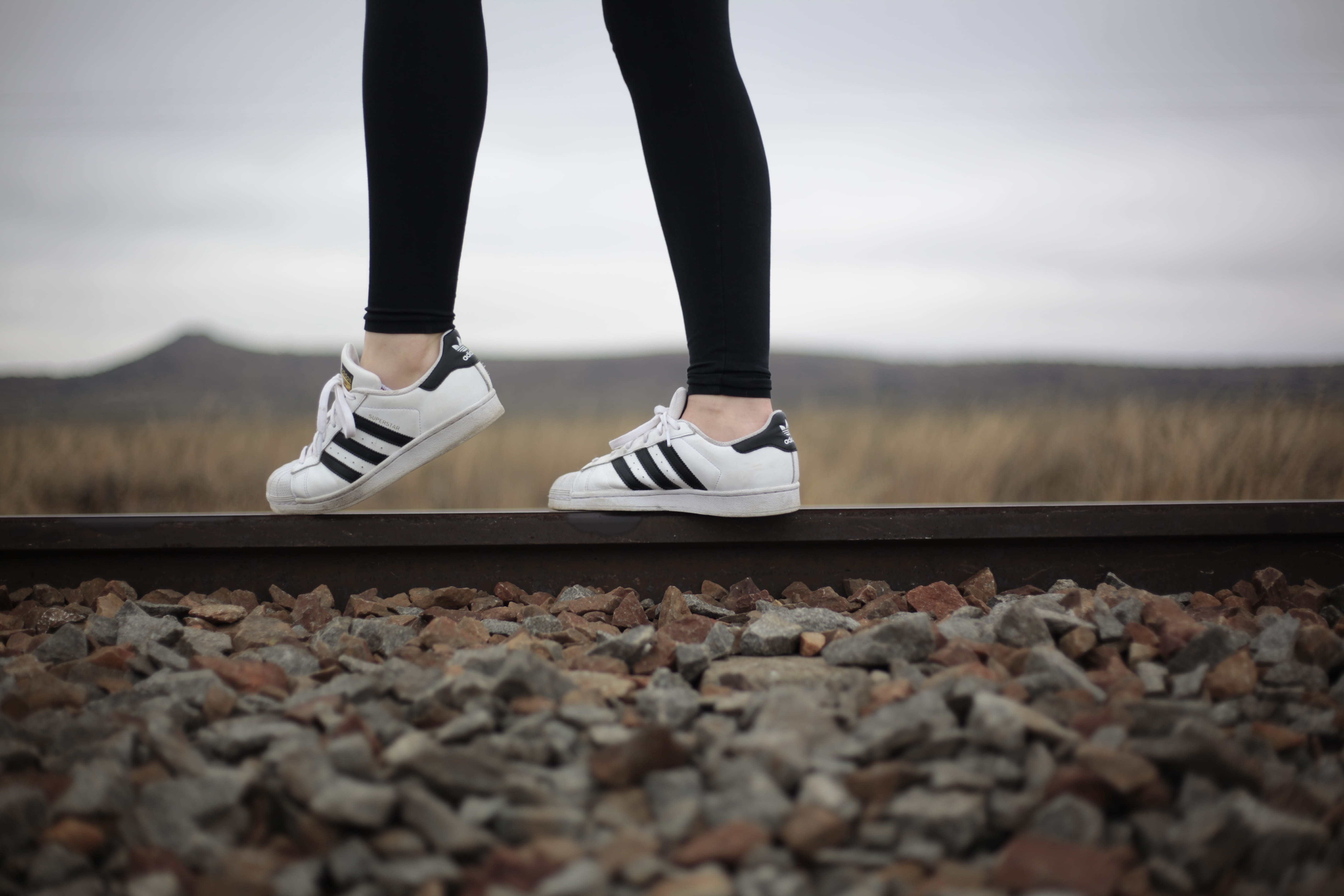 human limb, pebble, rail, human body part, rail transportation, woman, superstar, train, adidas, person, lifestyles, rock, white, focus, standing, body part, HD Wallpaper