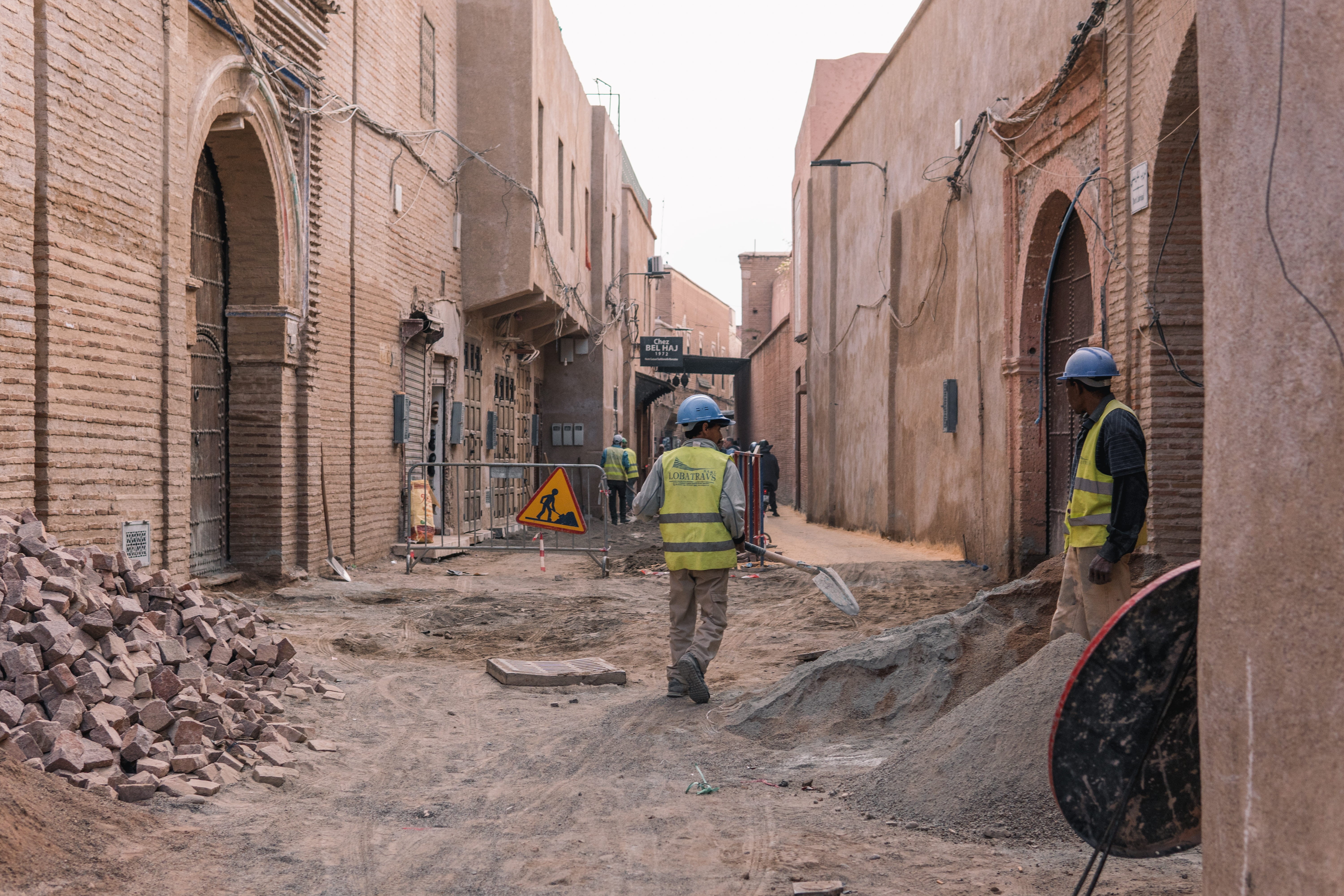 arabic city, built structure, pavement, hardhat, rear view, working, real people, human, headwear, urban, adult, nature, asphalt, outdoors, full length, HD Wallpaper