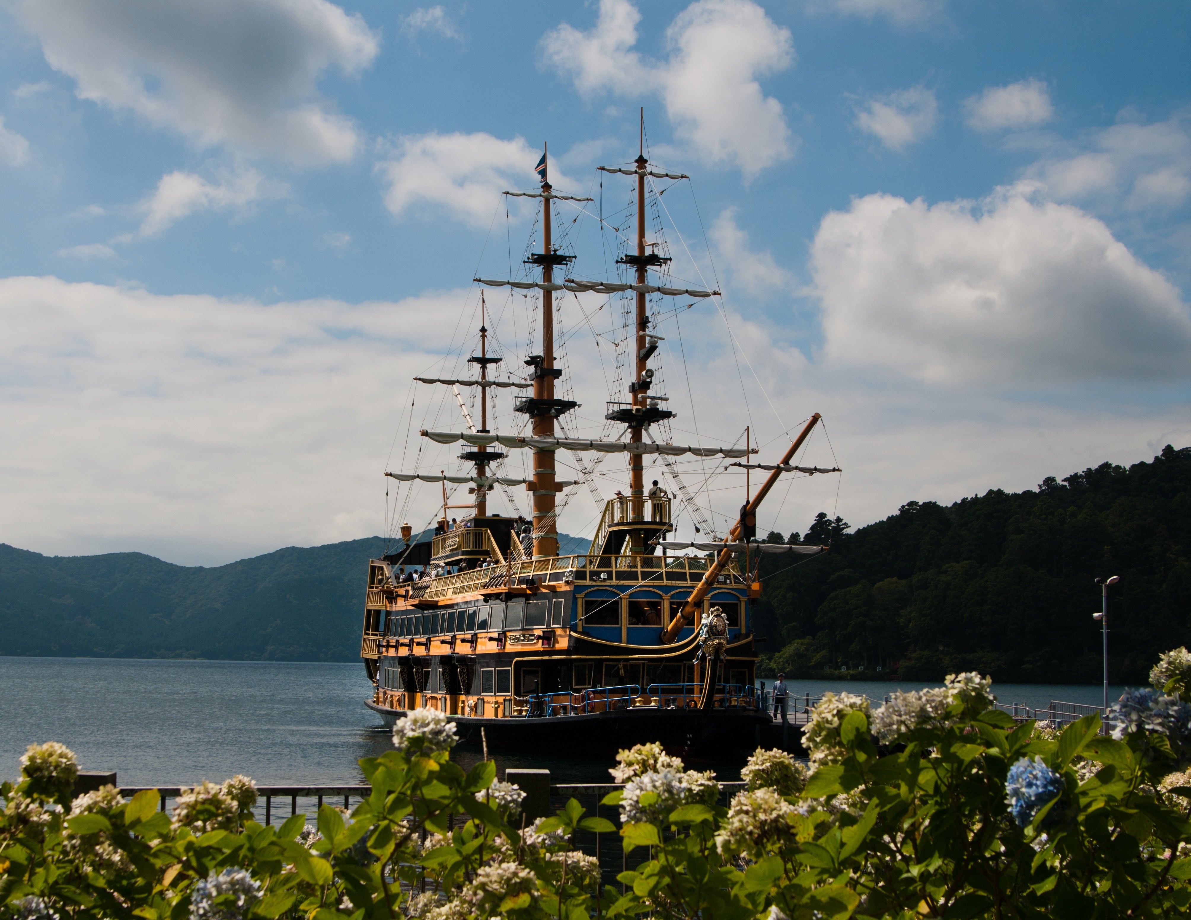 nautical vessel, boat, pole, sailboat, pirate, black, brown, near, sea, sky, day, tourism, water, mountain, japan, mast, outdoors, cloud - sky, transportation, HD Wallpaper