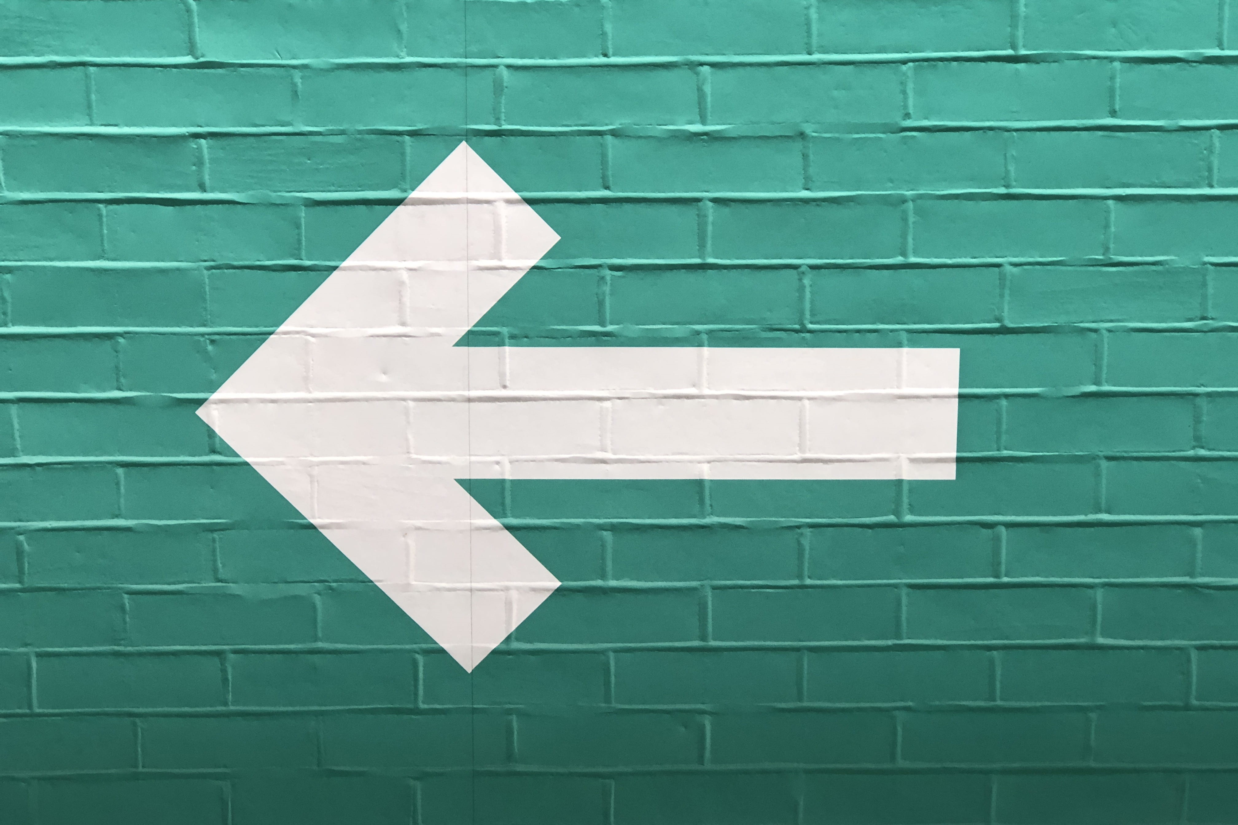 wall, letter, side, direction, monochrome, centre, communication, minimalism, guidance, minimal, white, green wall, built structure, brick wall, street sign, HD Wallpaper