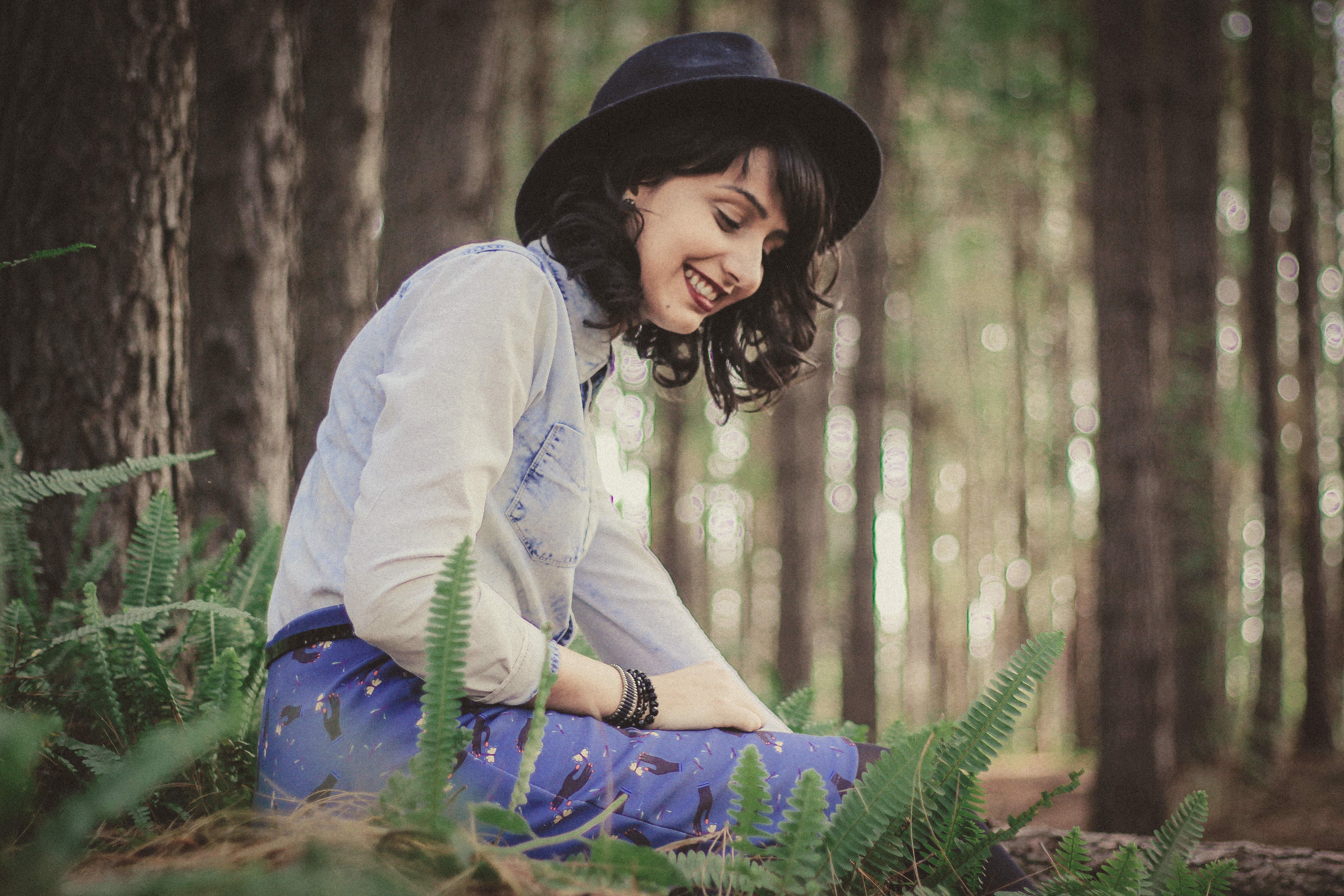 cap, fashion, nature, brown, tree, happy, trees, girl, bokeh, hairstyle, day, beside, black, blue, shirt, happiness, long hair, lifestyles, smiling, three quarter length, HD Wallpaper