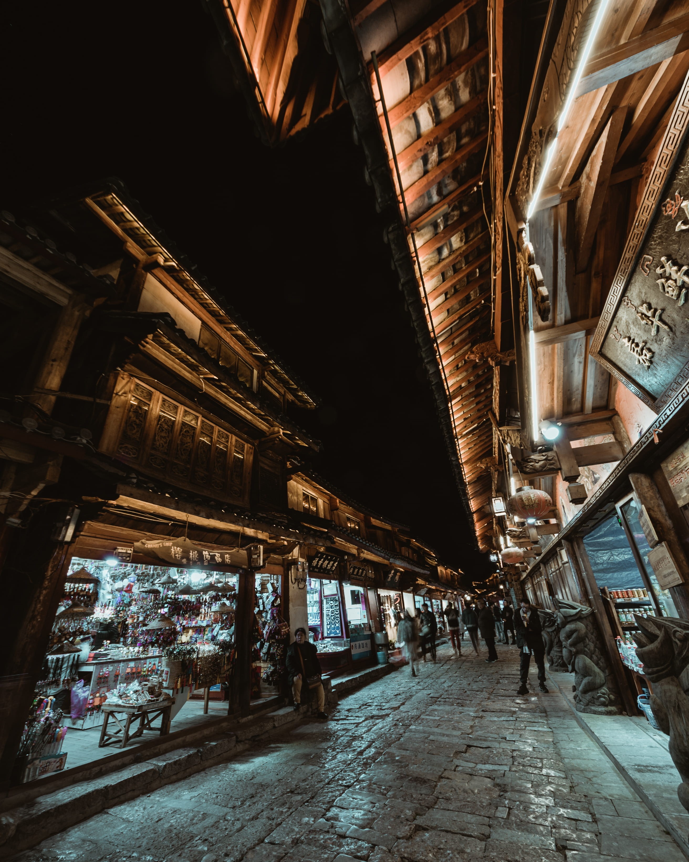 high, dark, stone, city, architectural column, marketplace, women, walking, shop, building, travel destinations, selling, cobble stone, sell, street photography, Phone HD Wallpaper