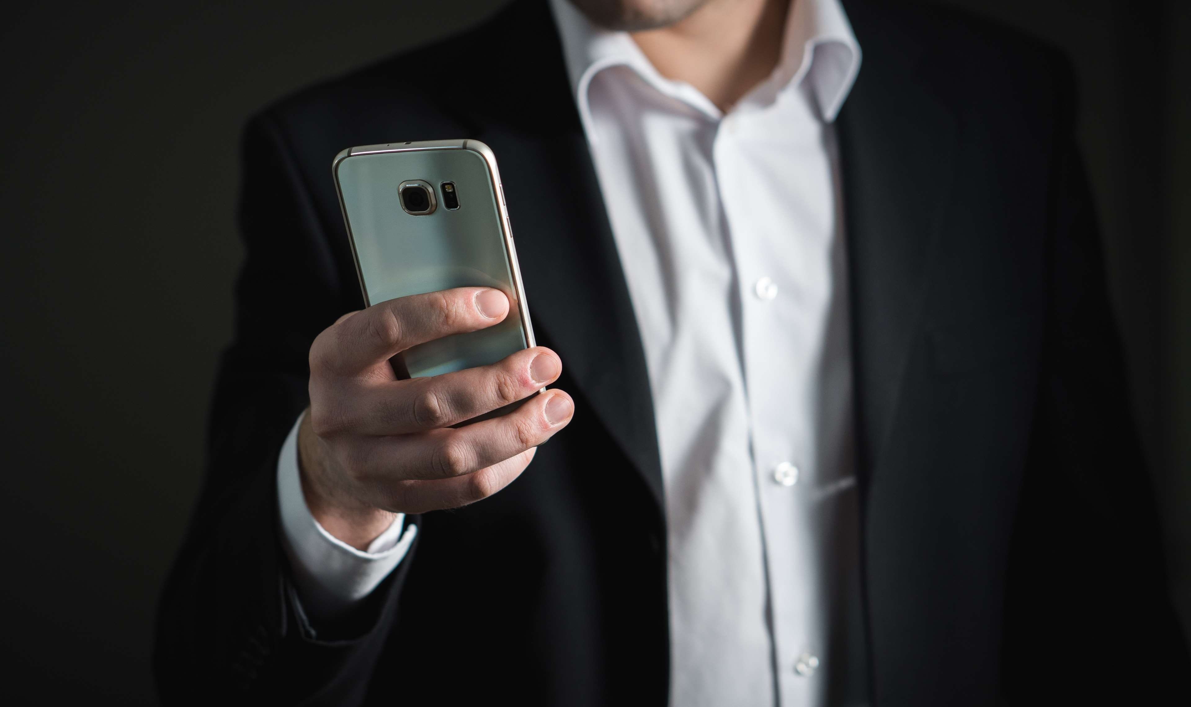 adult, busy, technology, black, formalwear, indoors, suit, portable information device, businessman, men, holding, smart phone, black background, business person, HD Wallpaper