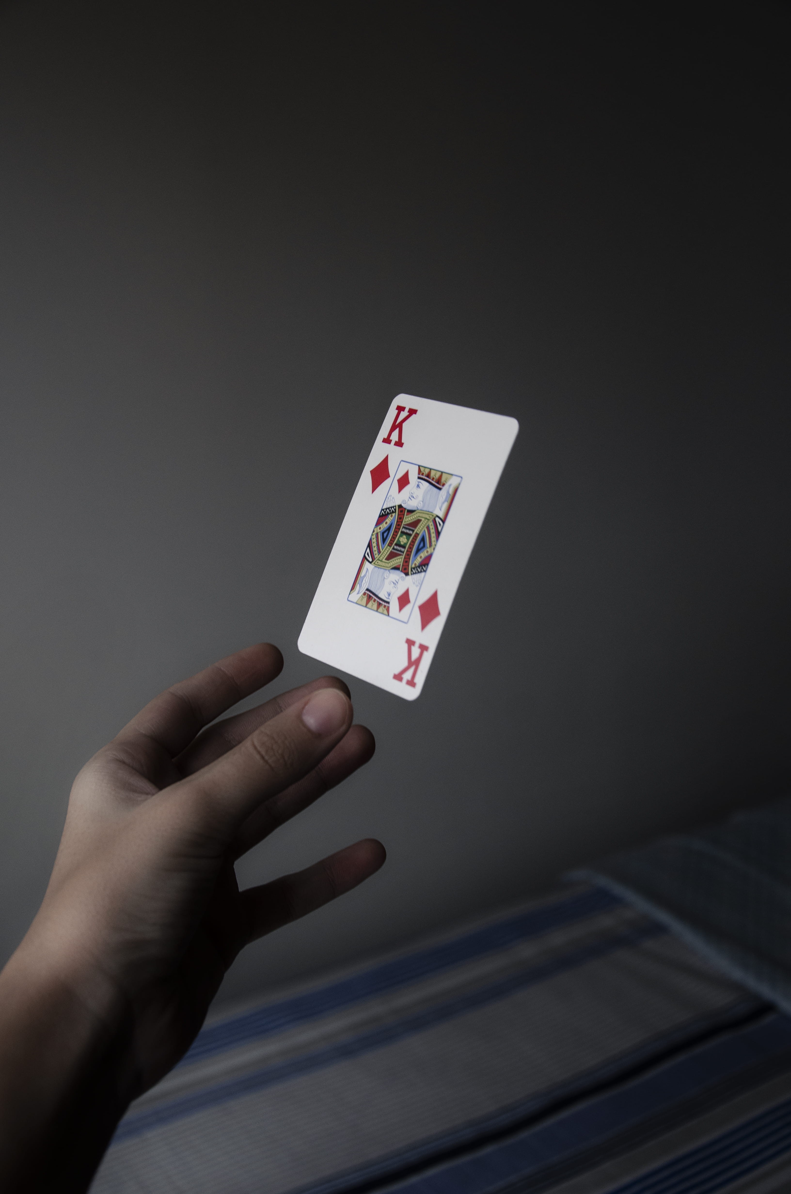 indoors, real people, finger, diamonds, king, luck, Joker, cards, one person, leisure activity, holding, floating, person, gambling, human body part, 4K, Phone HD Wallpaper