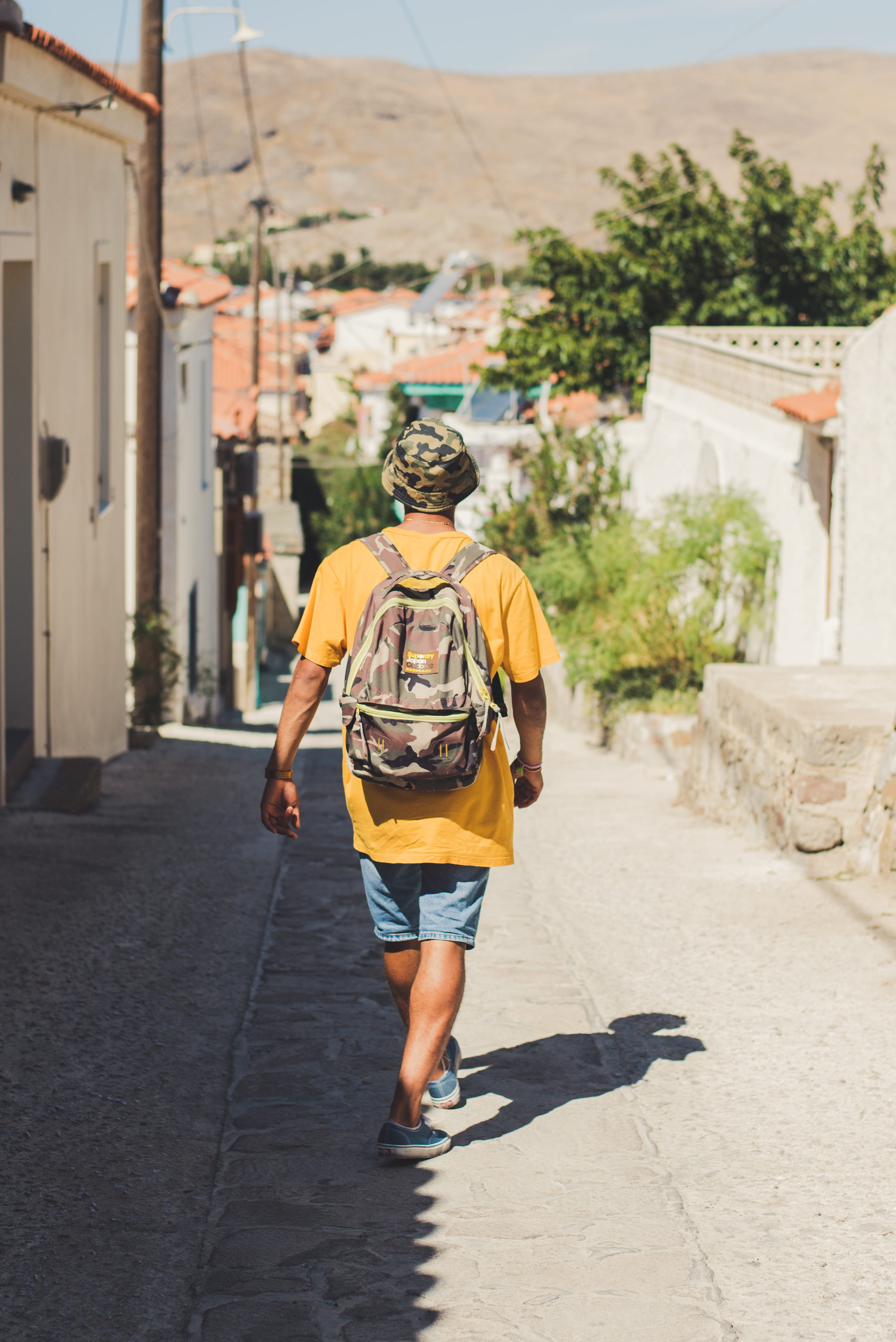 built structure, building, casual clothing, path, nature, shorts, village, outdoors, walking, summer, shirt, day, greece, lesbos, hairstyle, person, brown, Phone HD Wallpaper