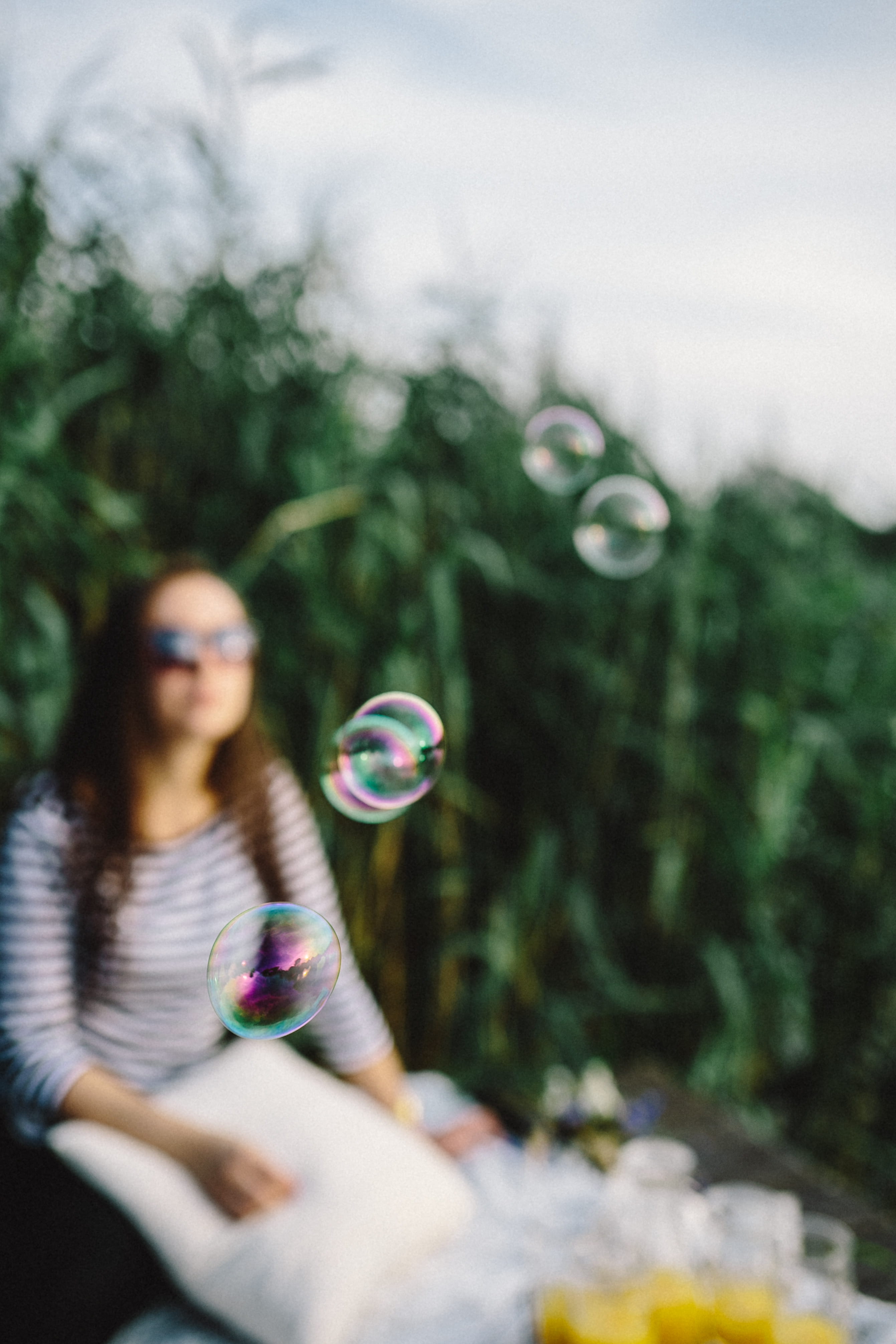 smiling, vulnerability, holidays, summer, happy, playing, mid-air, bubble Wand, one Person, real people, day, happiness, plant, 4K, soap, outdoors, enjoyment, Phone HD Wallpaper