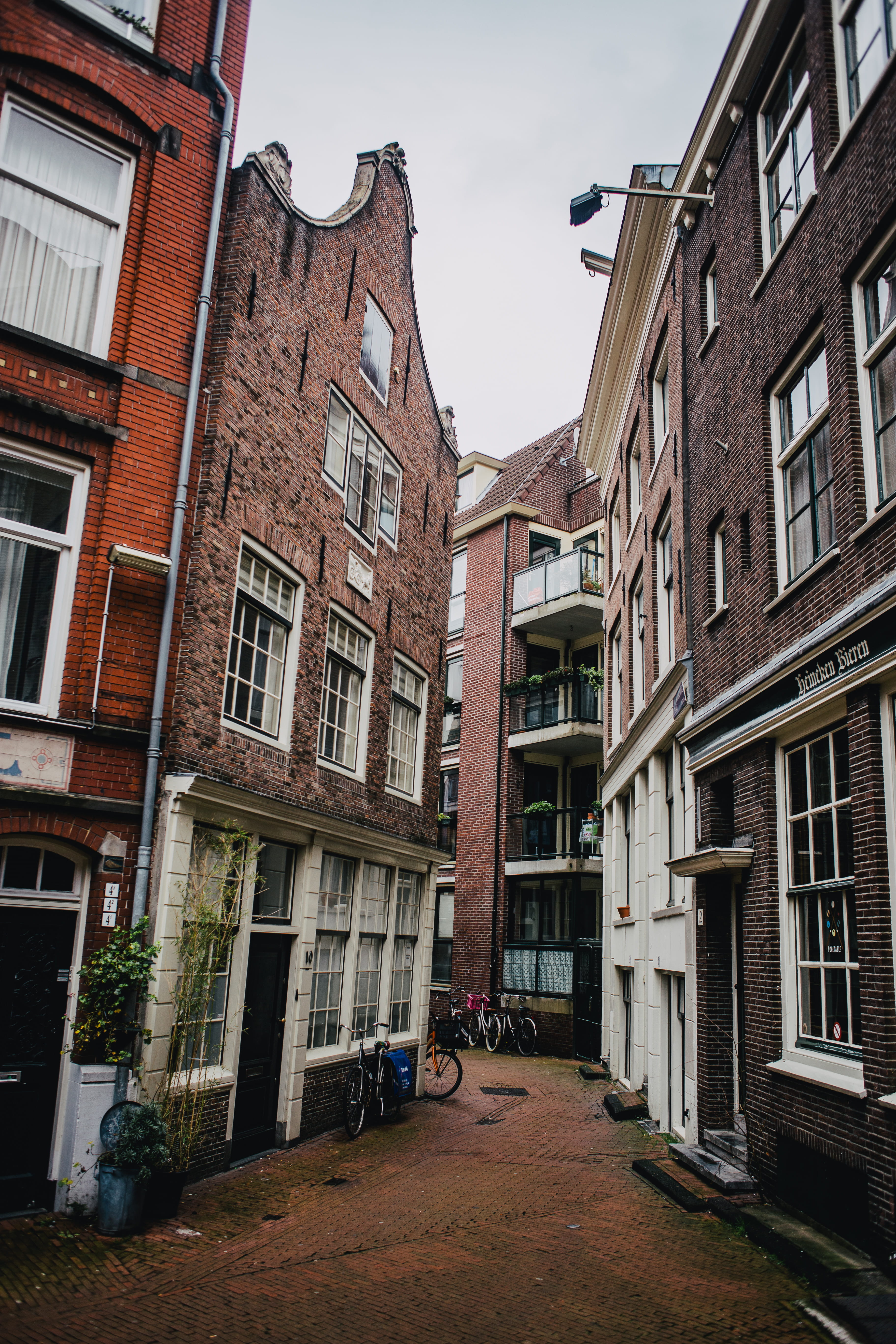low angle view, home decor, row house, residential district, apartment, 5K, bike, building exterior, window, urban, quirky, no people, walkway, alley, Phone HD Wallpaper