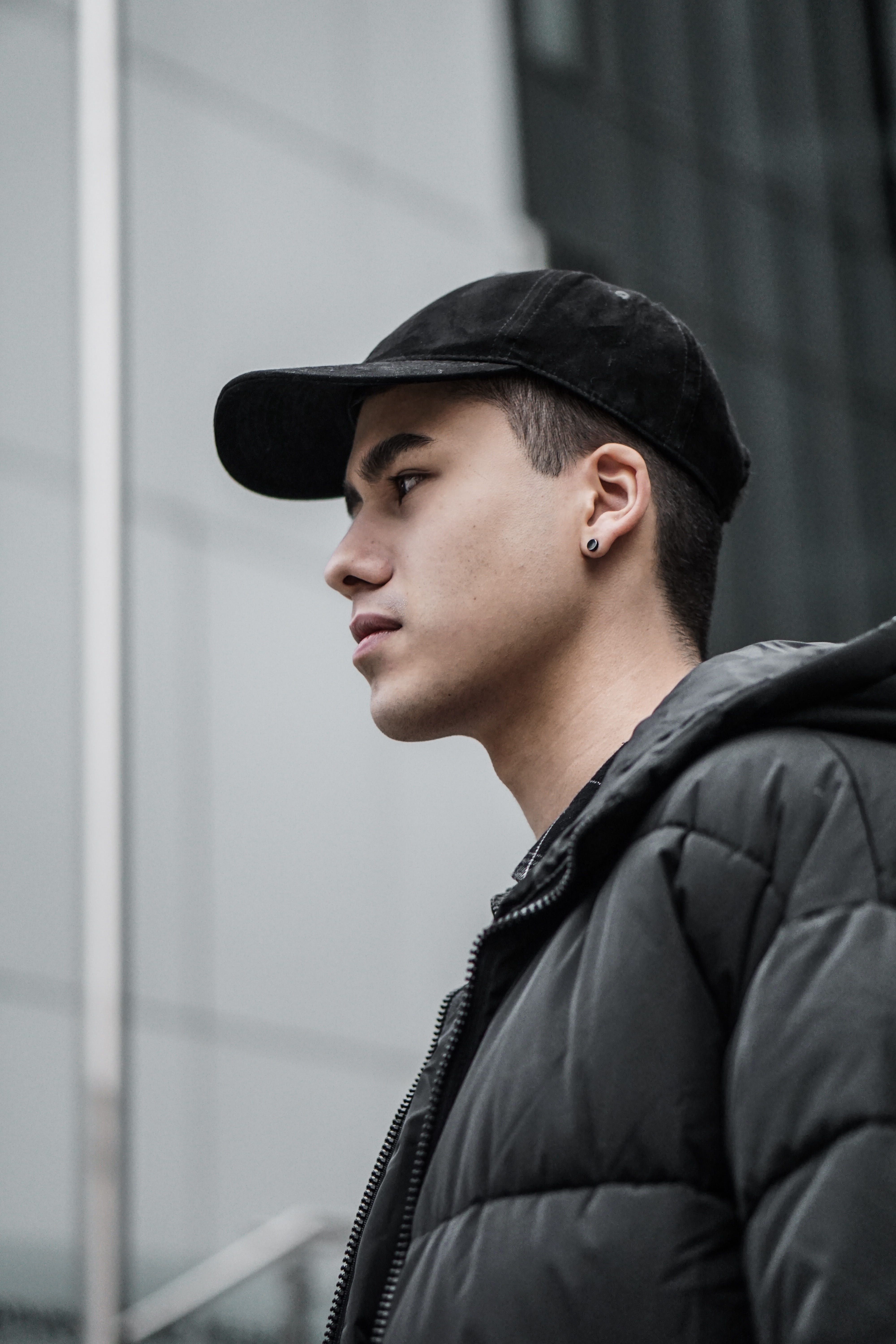 jacket, contemplation, lifestyles, profile view, cap, coat, young adult, black, side view, looking out, face, human, leisure activity, teenager, city, one person, Phone HD Wallpaper