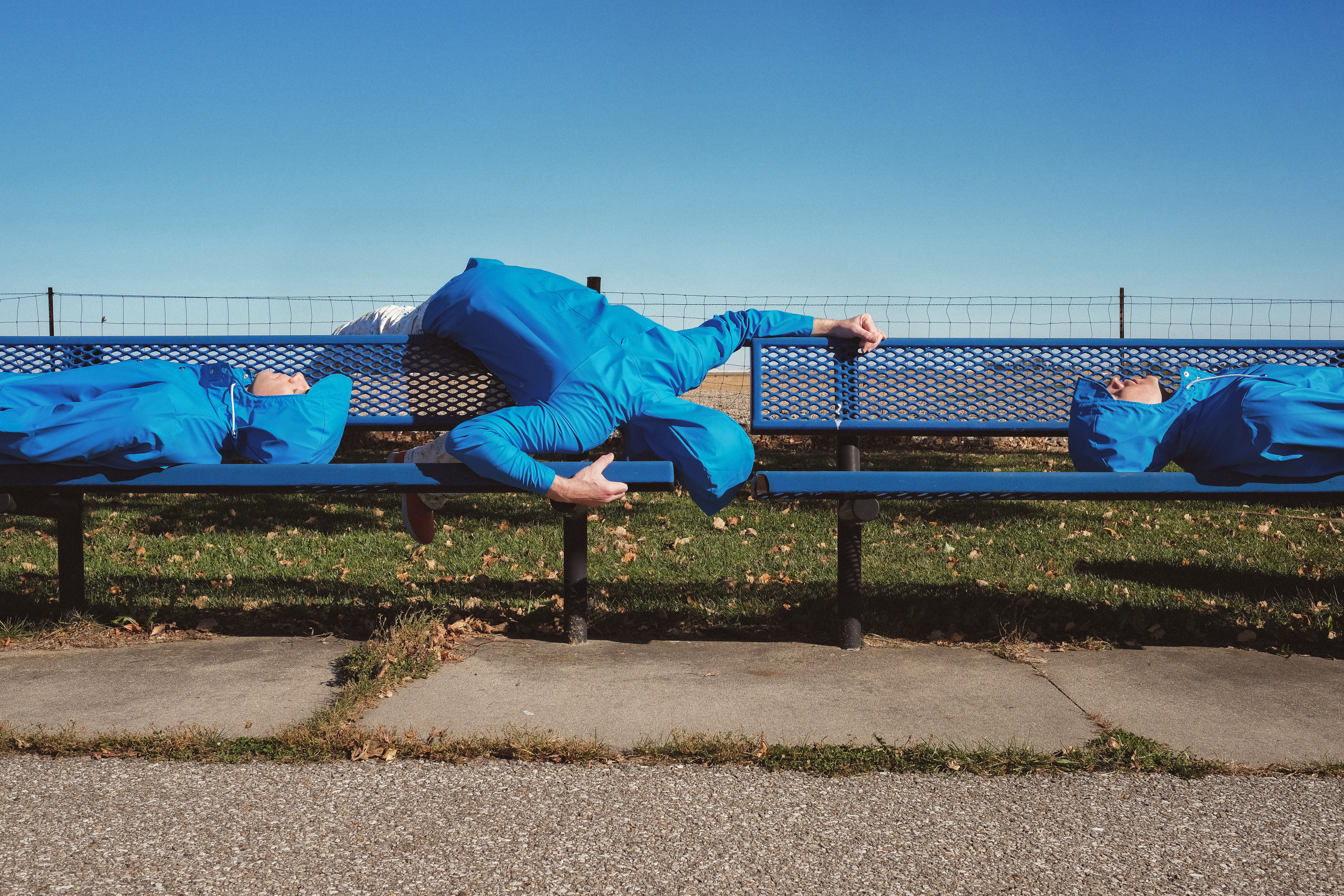 adults only, leisure activity, clear sky, person, in blue, 5K, sky, fence, whimsical, adult, real people, photo, day, laying, jacket, boundary, wearing, HD Wallpaper