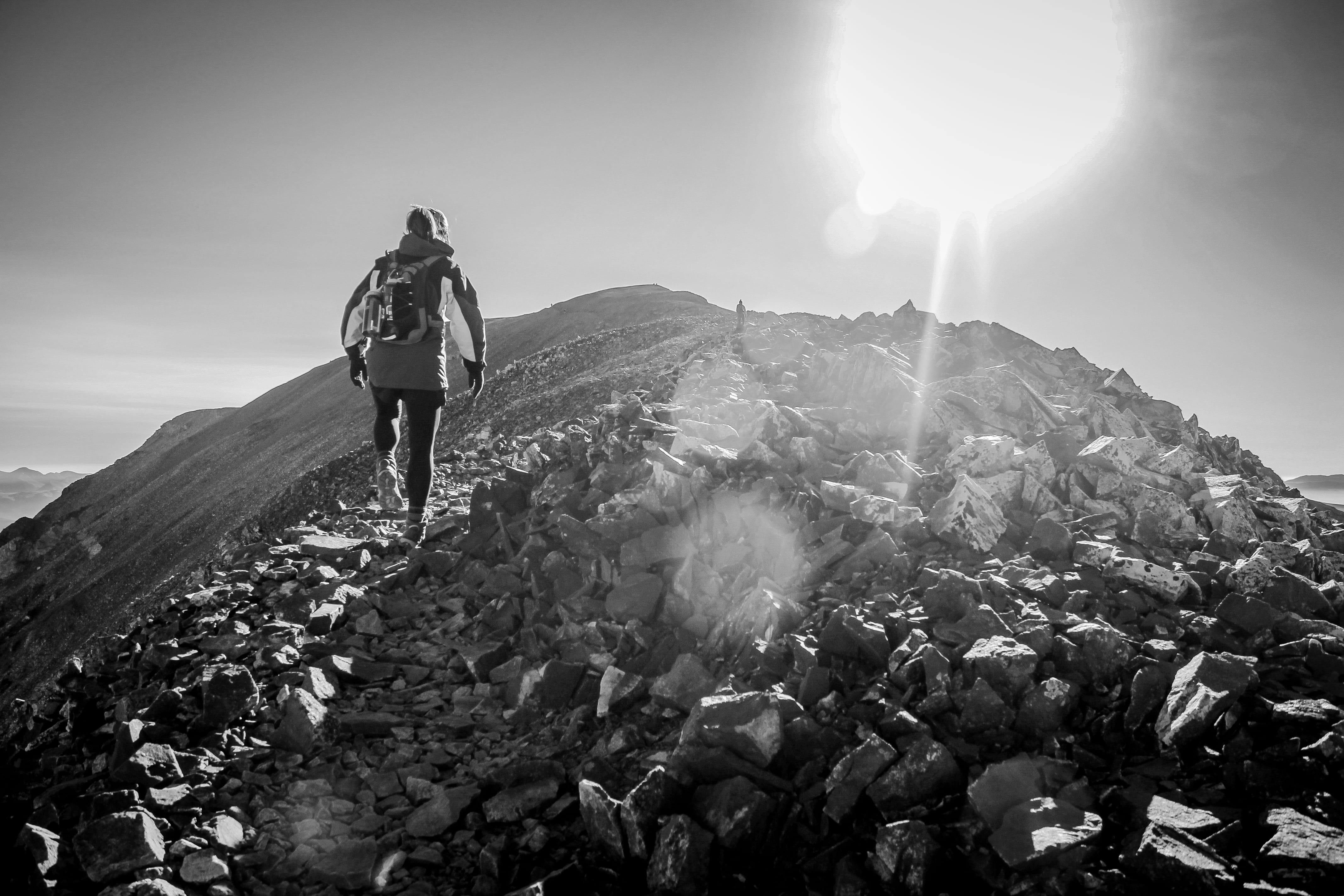 woman, peak, trail, rock, sunlight, hiking, lifestyles, alma, activity, push, rock - object, lens flare, 4K, black and white, mountain, victory, scenics - nature, HD Wallpaper